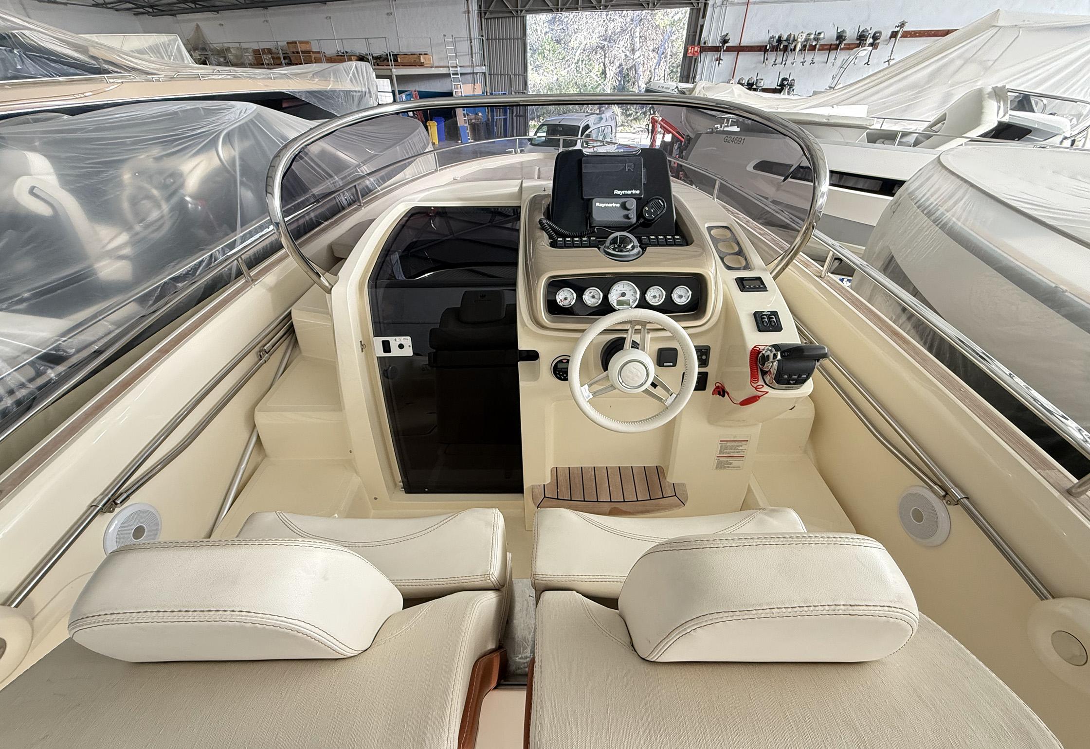 Interior view of 2017 Invictus 280 GT boat, featuring a sleek dashboard and comfortable seating.