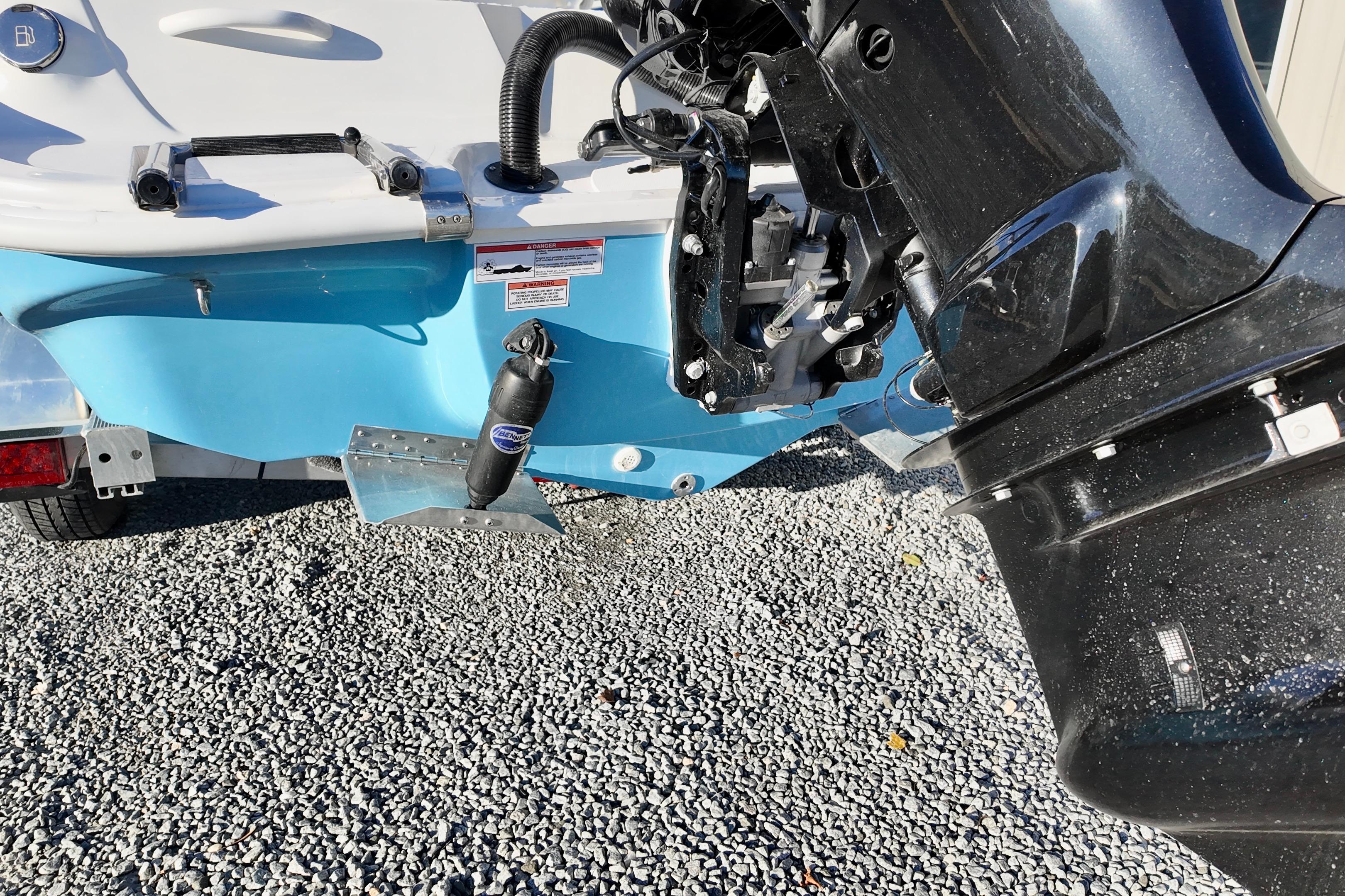 2025 ALK2 Powerboats 23 CRX rear view with motor and blue hull.