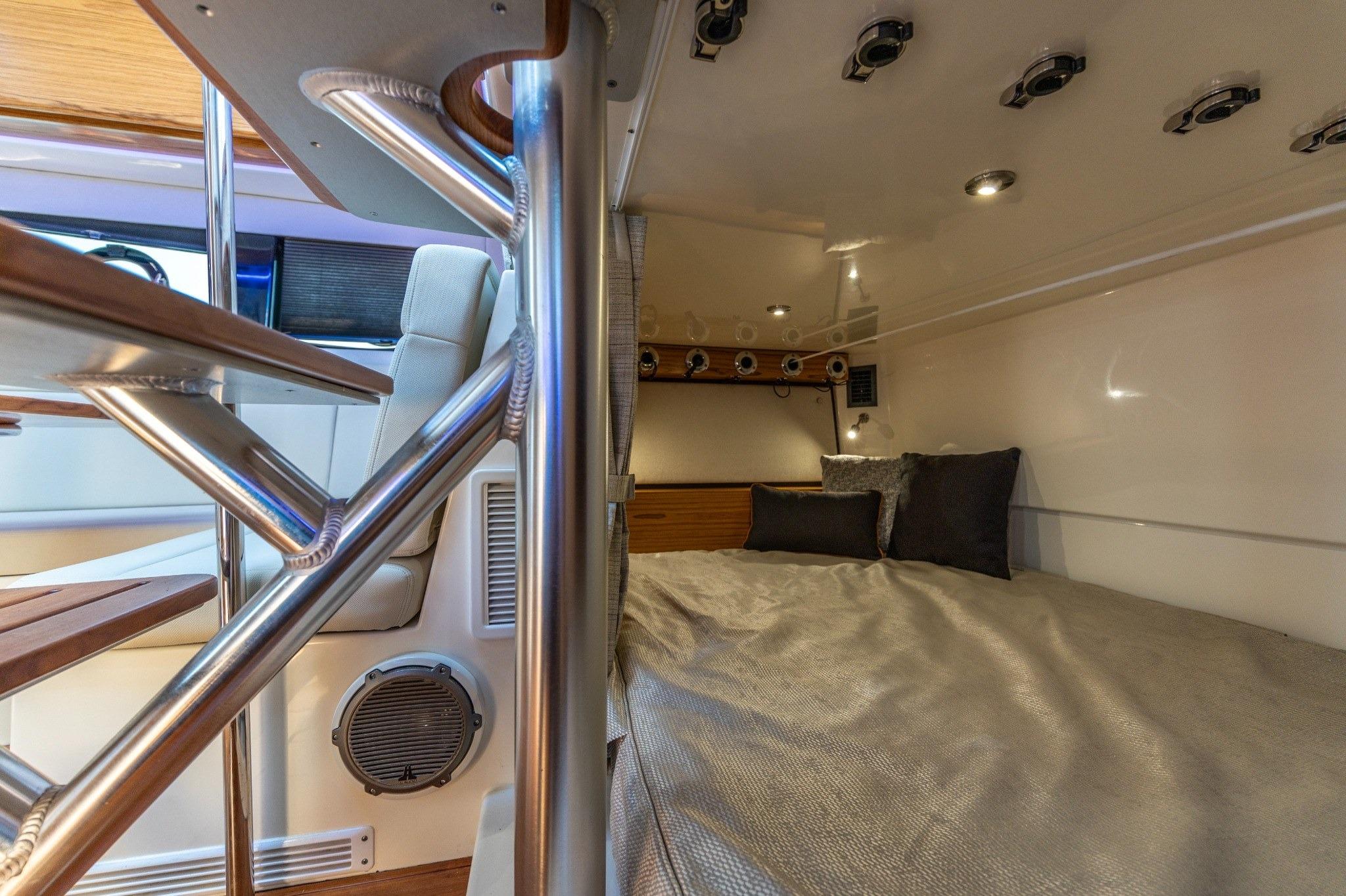 2023 Boston Whaler 405 Conquest cabin interior with bed and modern design elements.
