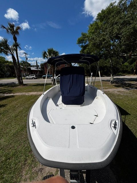 A 2008 Boston Whaler 200 Dauntless on a trailer, surrounded by trees.