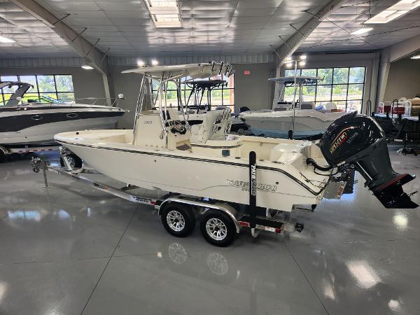 2025 Pathfinder 2400 Open boat in showroom, on trailer, with outboard motor.