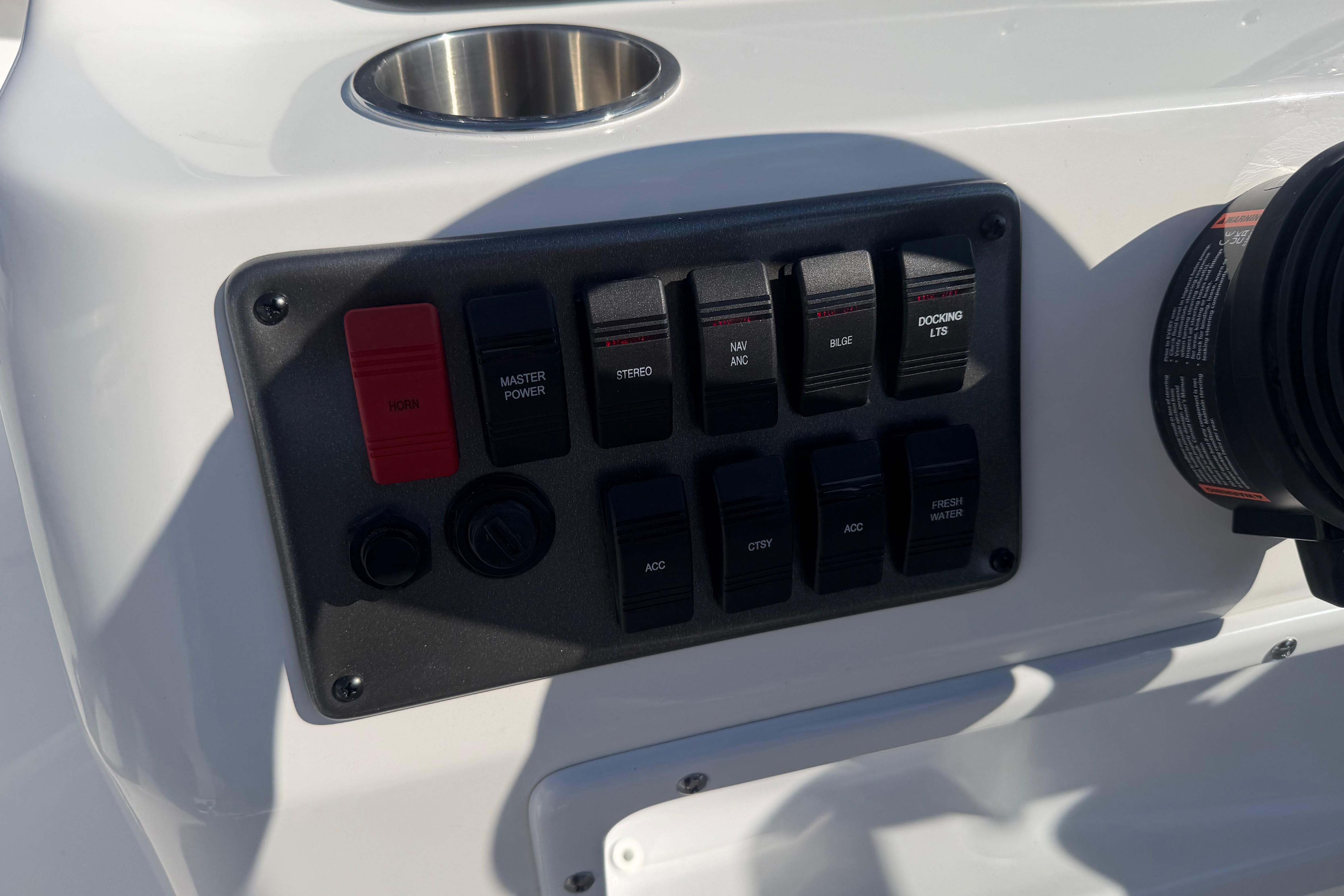 Control panel of 2026 Hurricane FunDeck 198 RE OB boat with various switches.