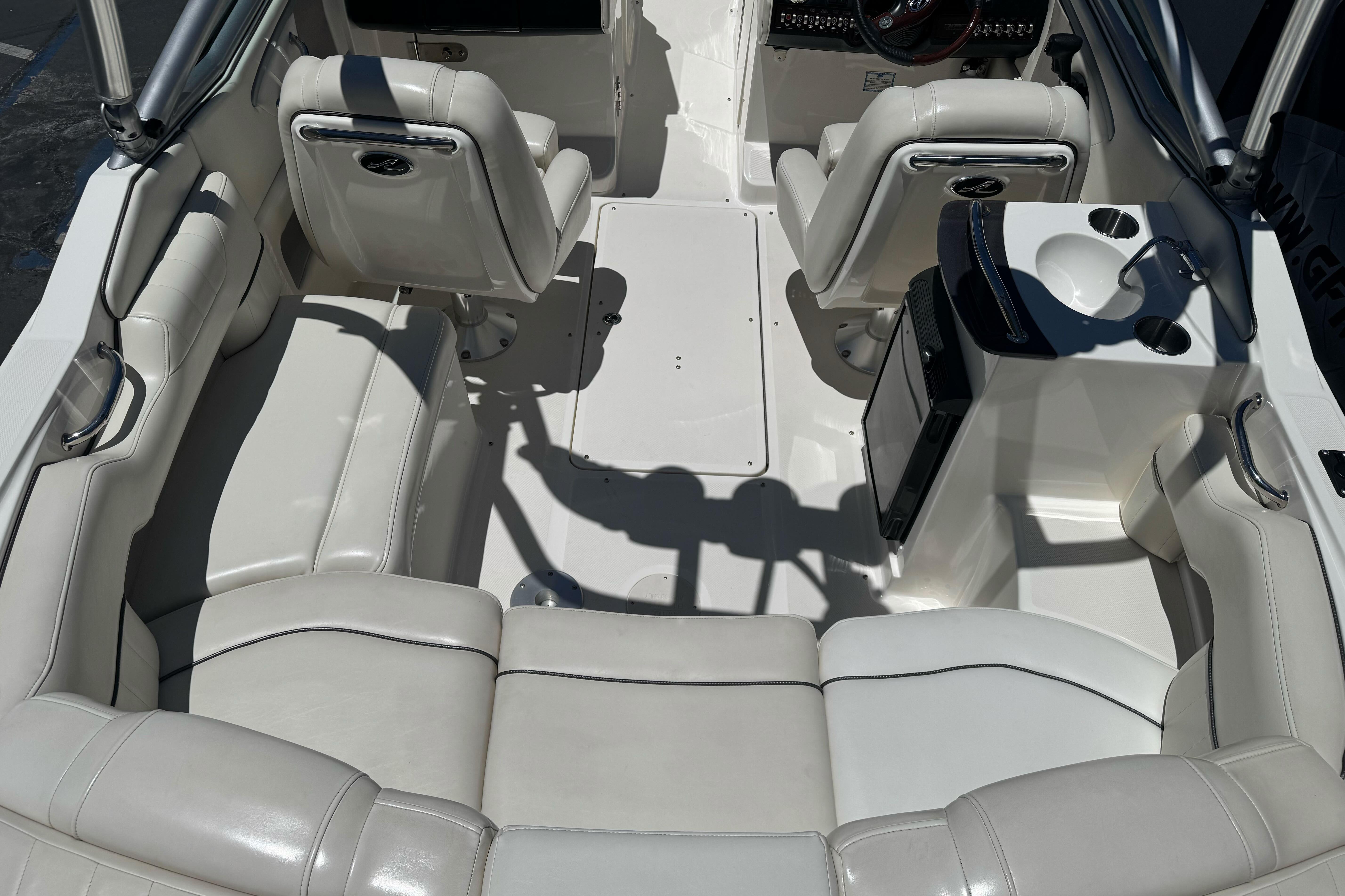 Interior of a 2007 Sea Ray SLX 250 boat with white leather seating and helm.