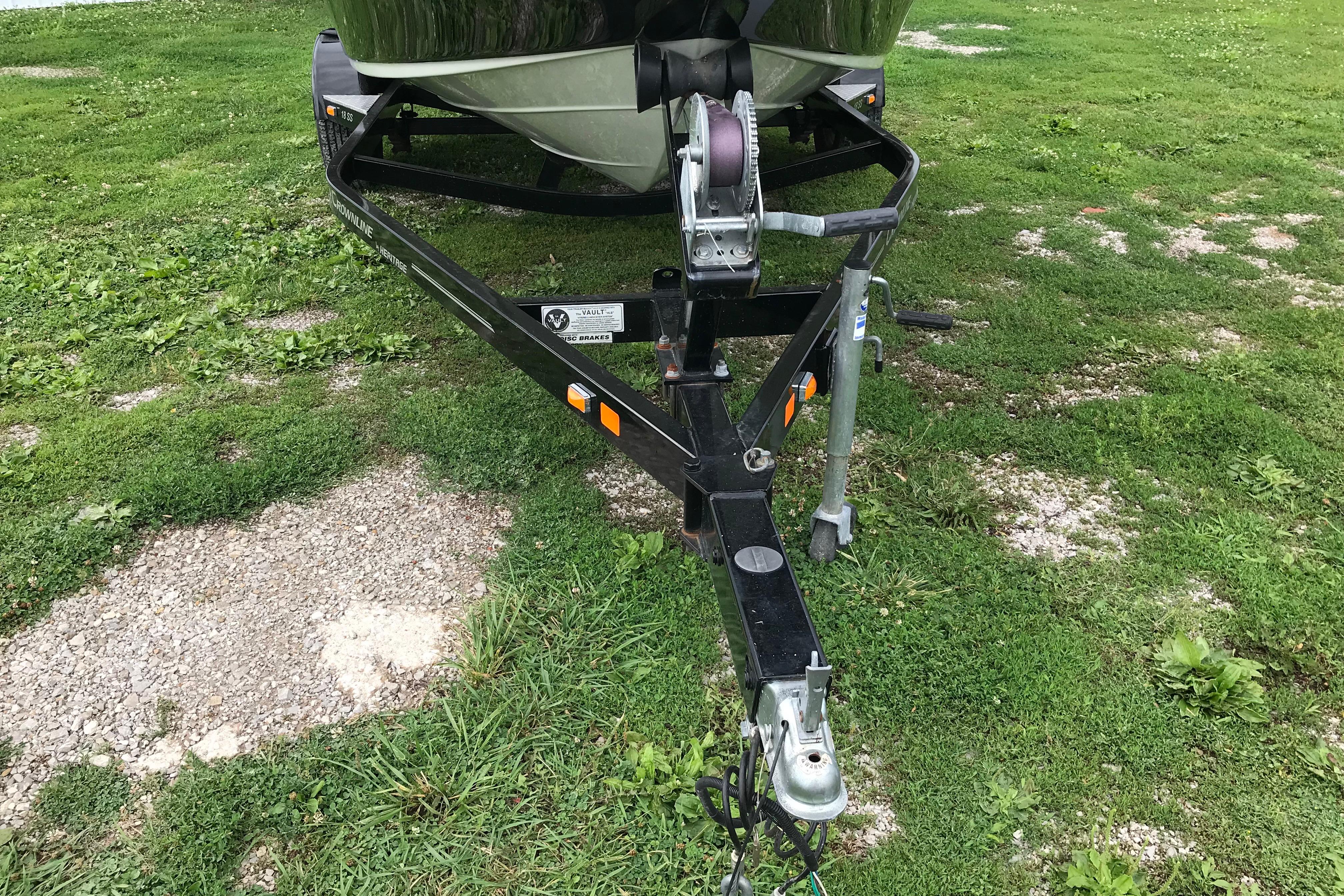 2015 Crownline 18 SS boat trailer on grassy surface.