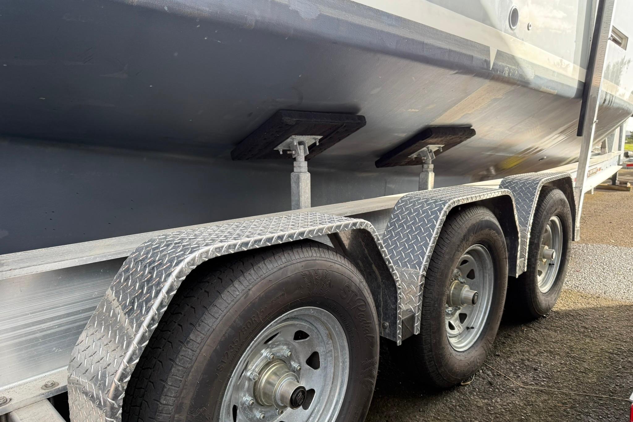 Trailer with SeaPiper 35 boat, 2020 model, featuring triple axle wheels.