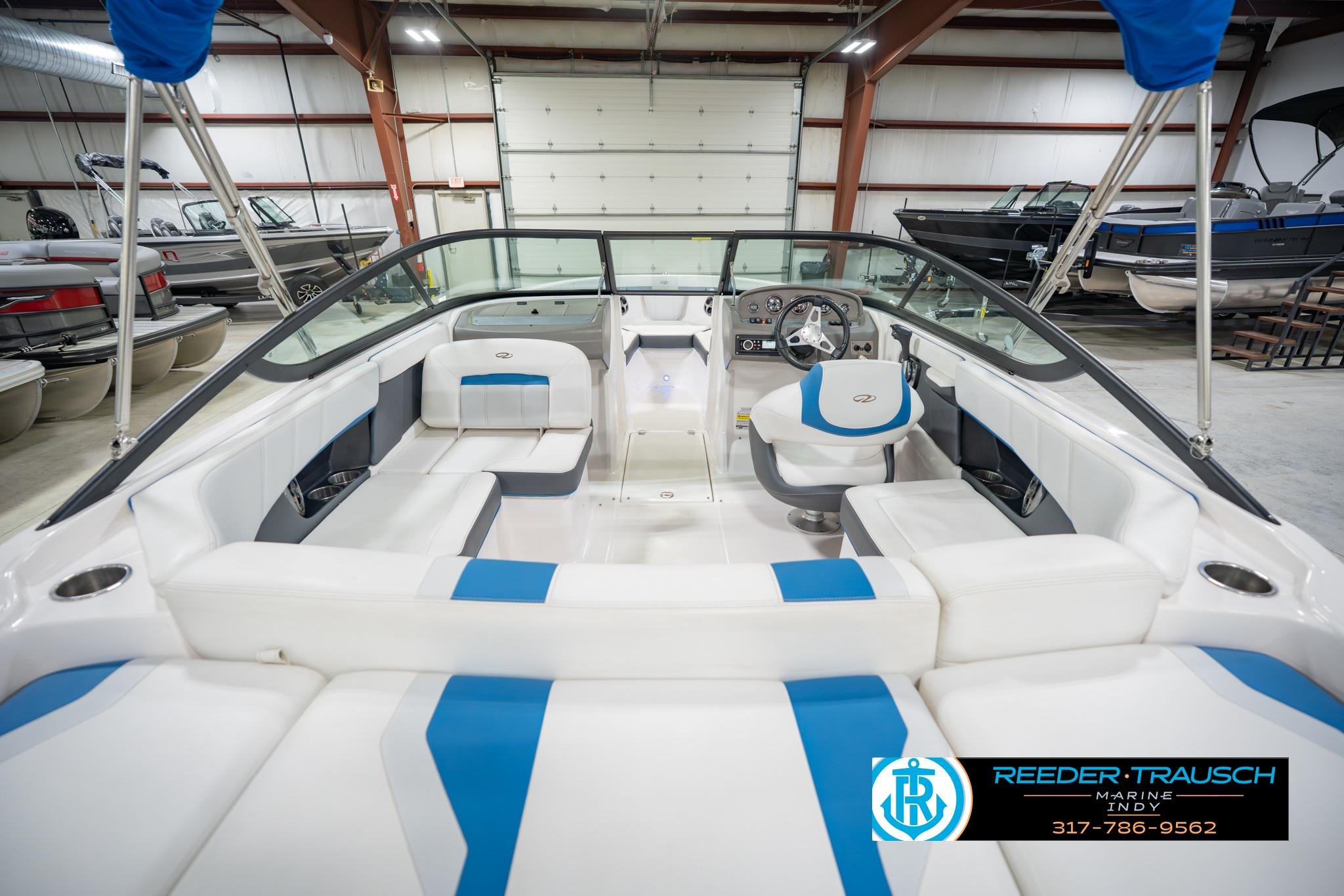 2015 Regal 2000 ESX Bowrider interior with blue and white seating in a showroom.