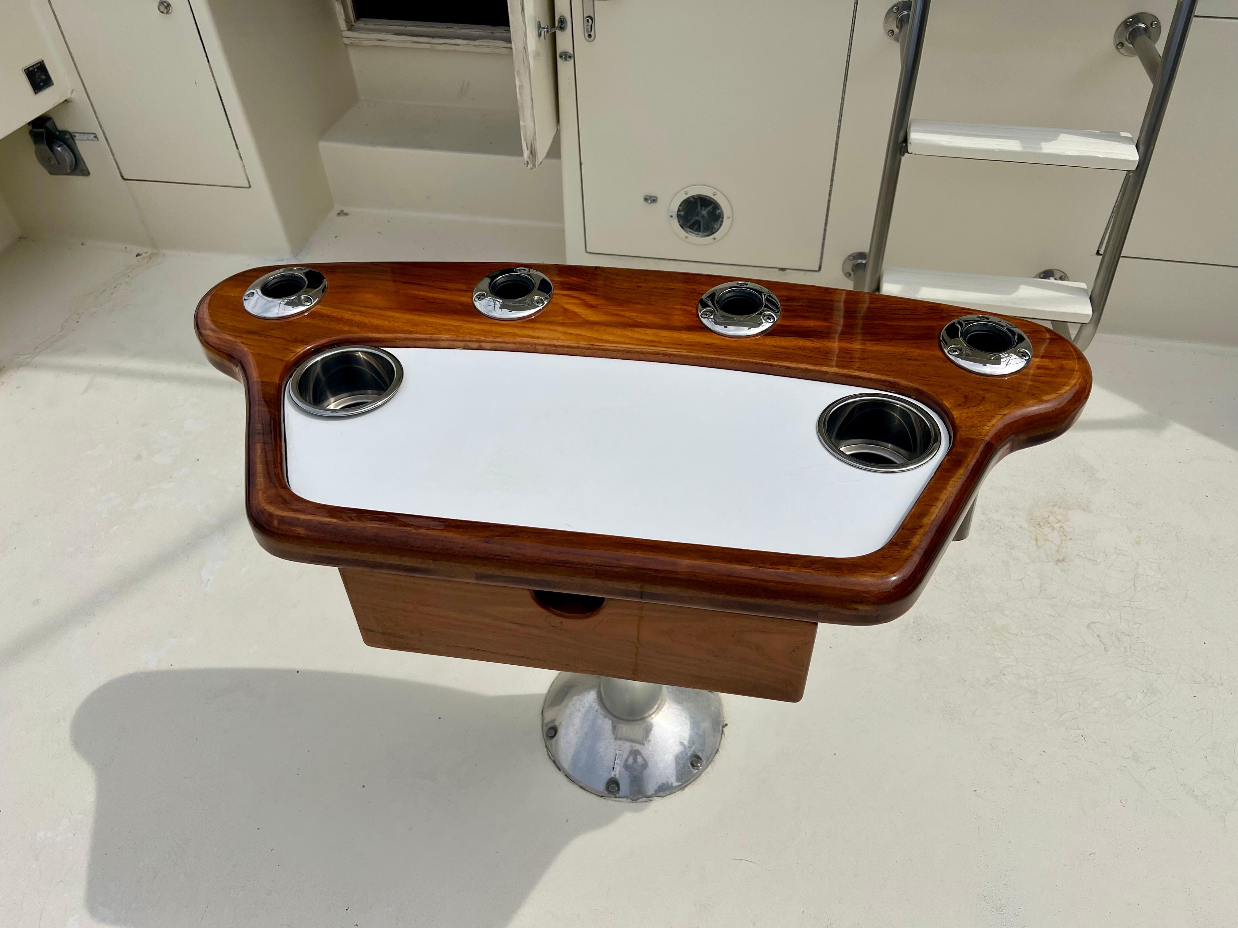 Fishing station on 1988 Hatteras 48 Convertible yacht with rod holders and cup holders.