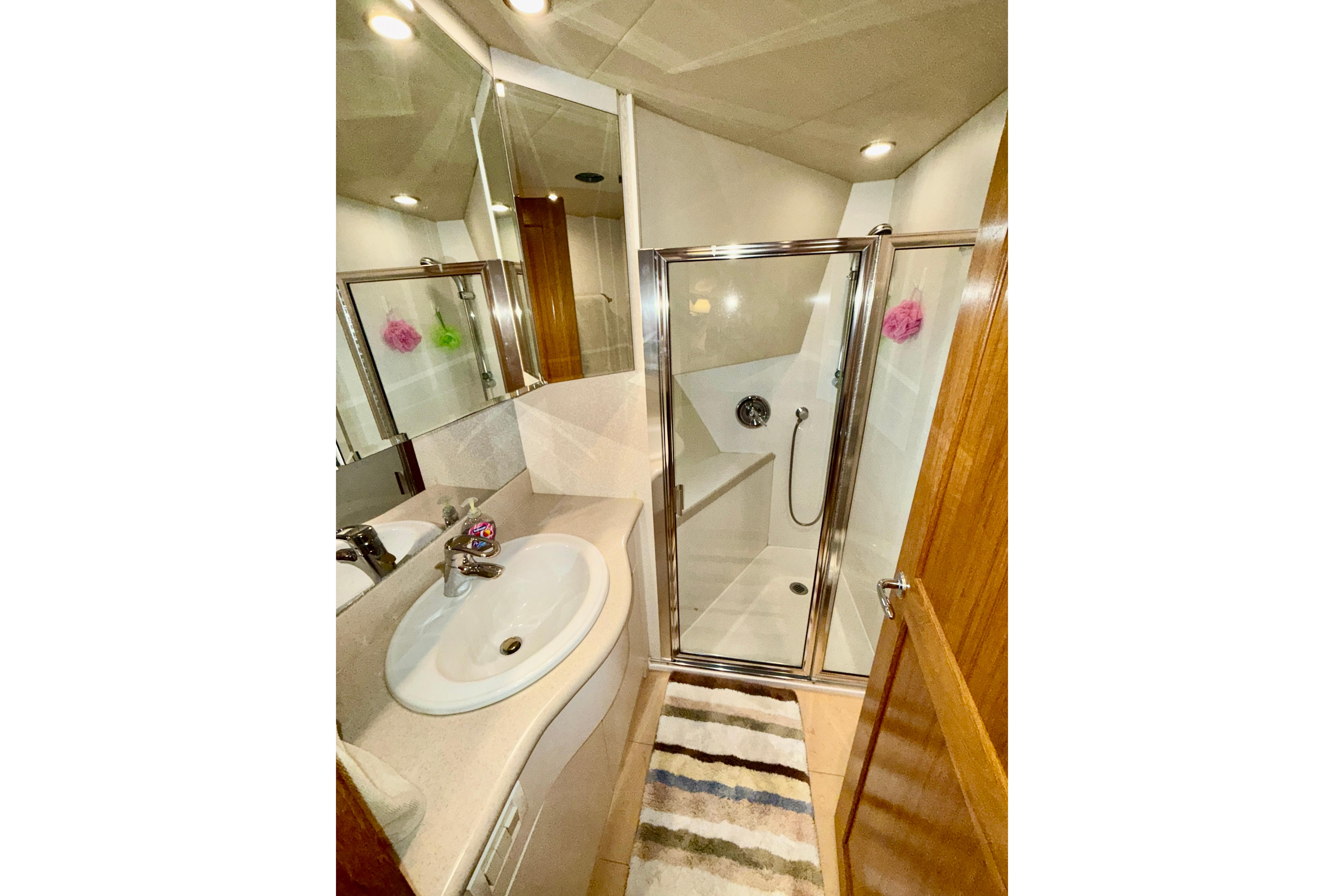Bathroom interior of 2001 Pacific Mariner 65 Motoryacht with shower and sink.