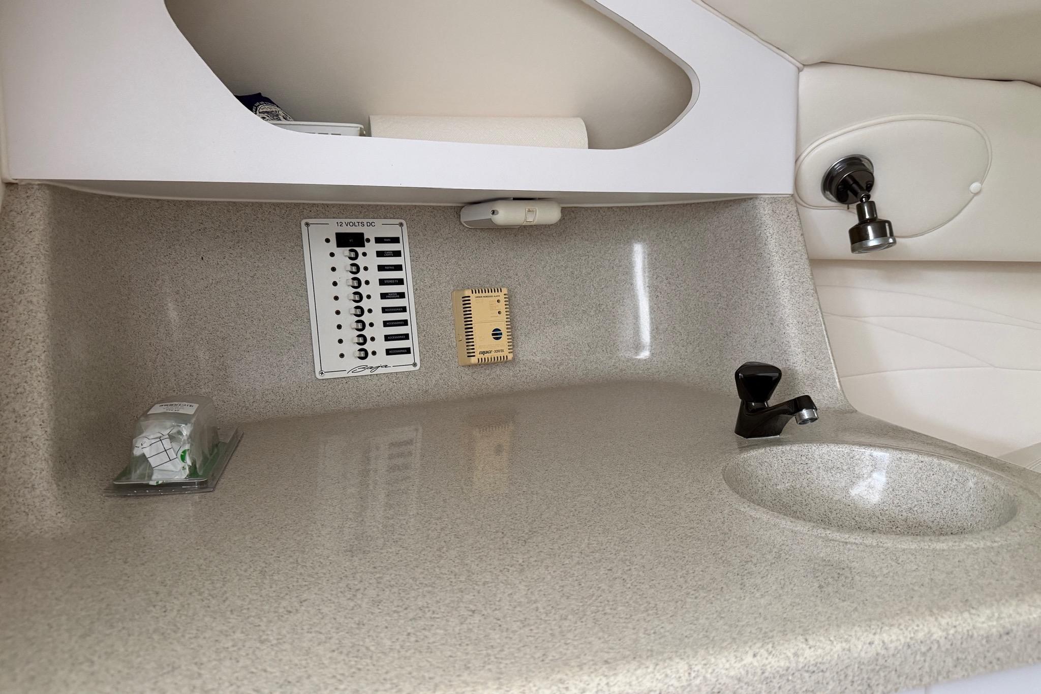 2001 Baja 33 Outlaw boat interior with control panel and sink.