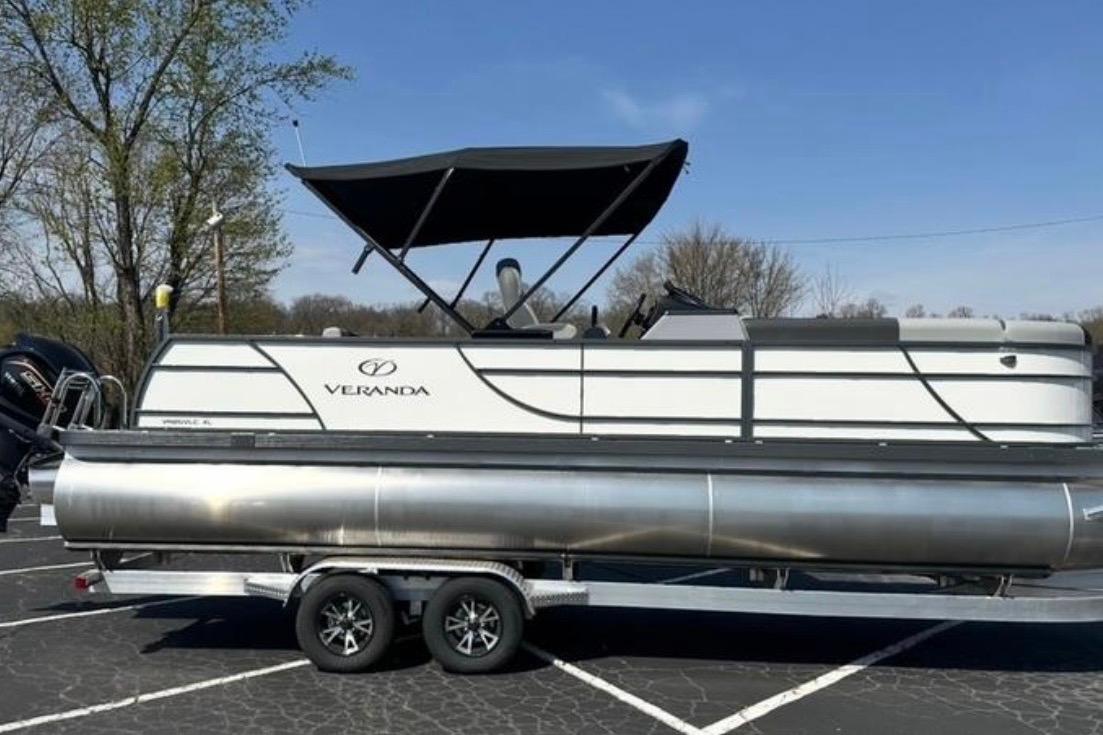 2025 Veranda Relax VR25VLC pontoon boat on trailer, parked outdoors.