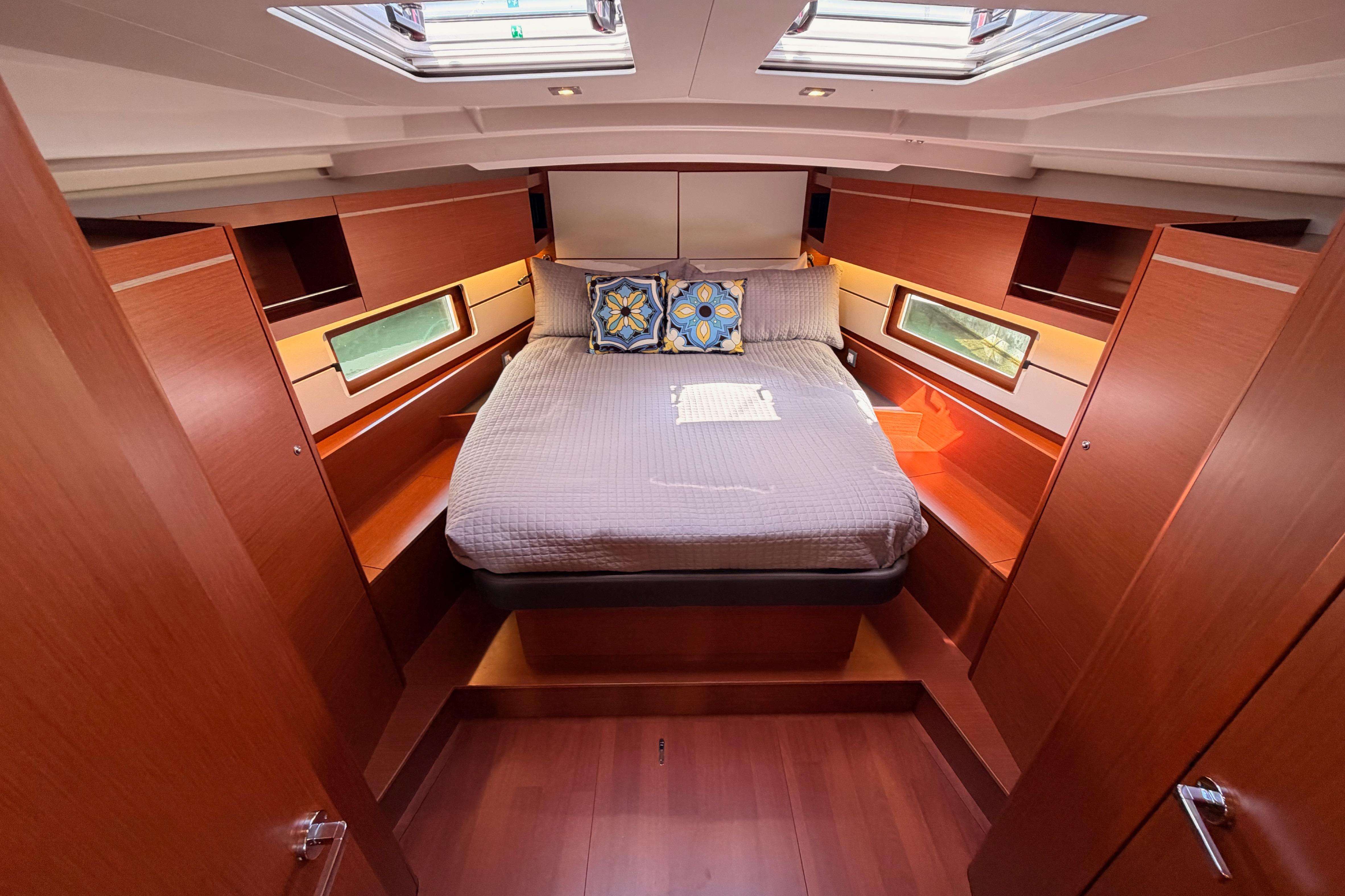 Luxurious cabin interior of 2020 Beneteau Oceanis 46.1 yacht with cozy bedding.