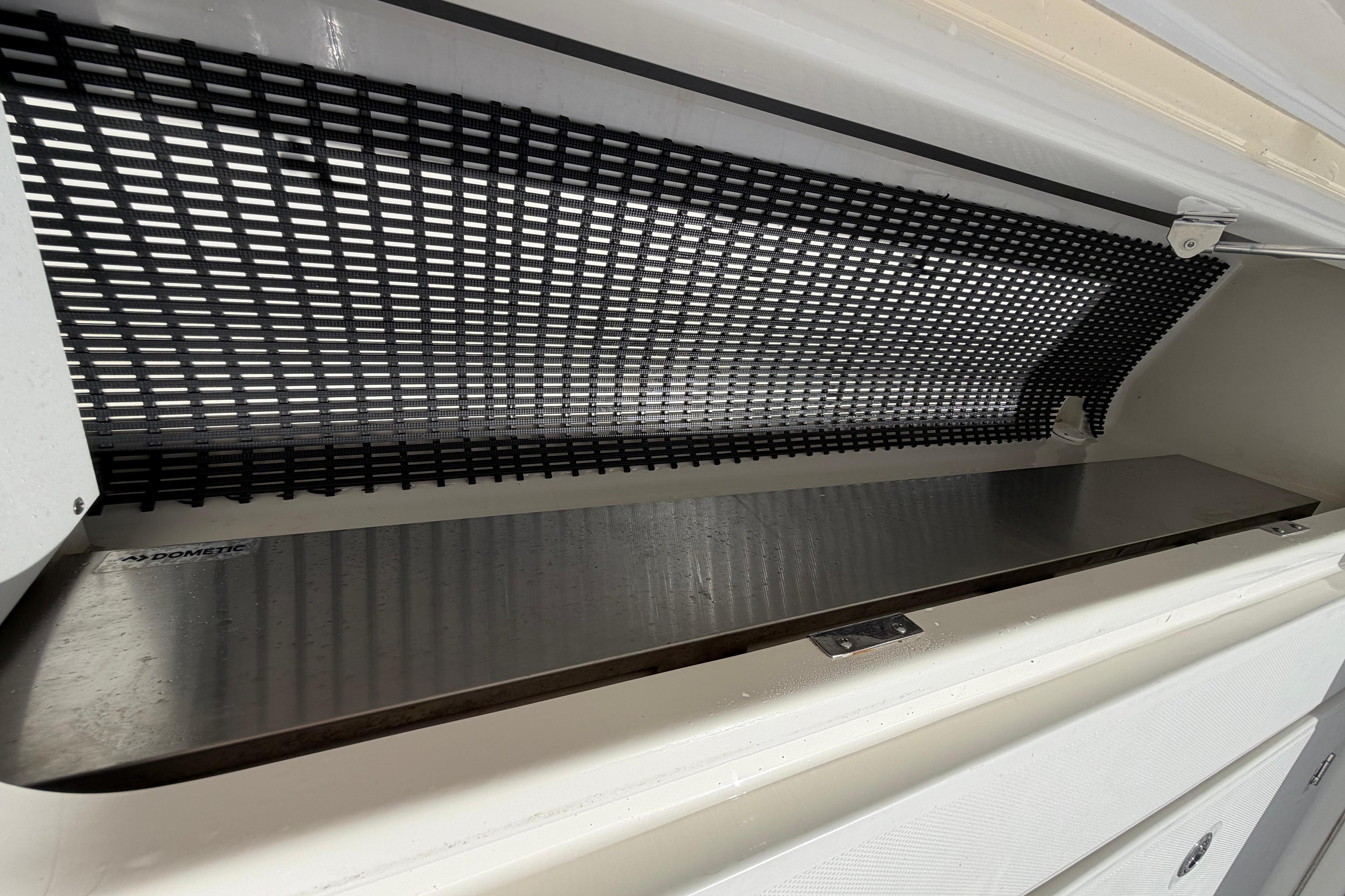 Storage compartment on a 2019 Boston Whaler 420 Outrage boat with mesh lining.
