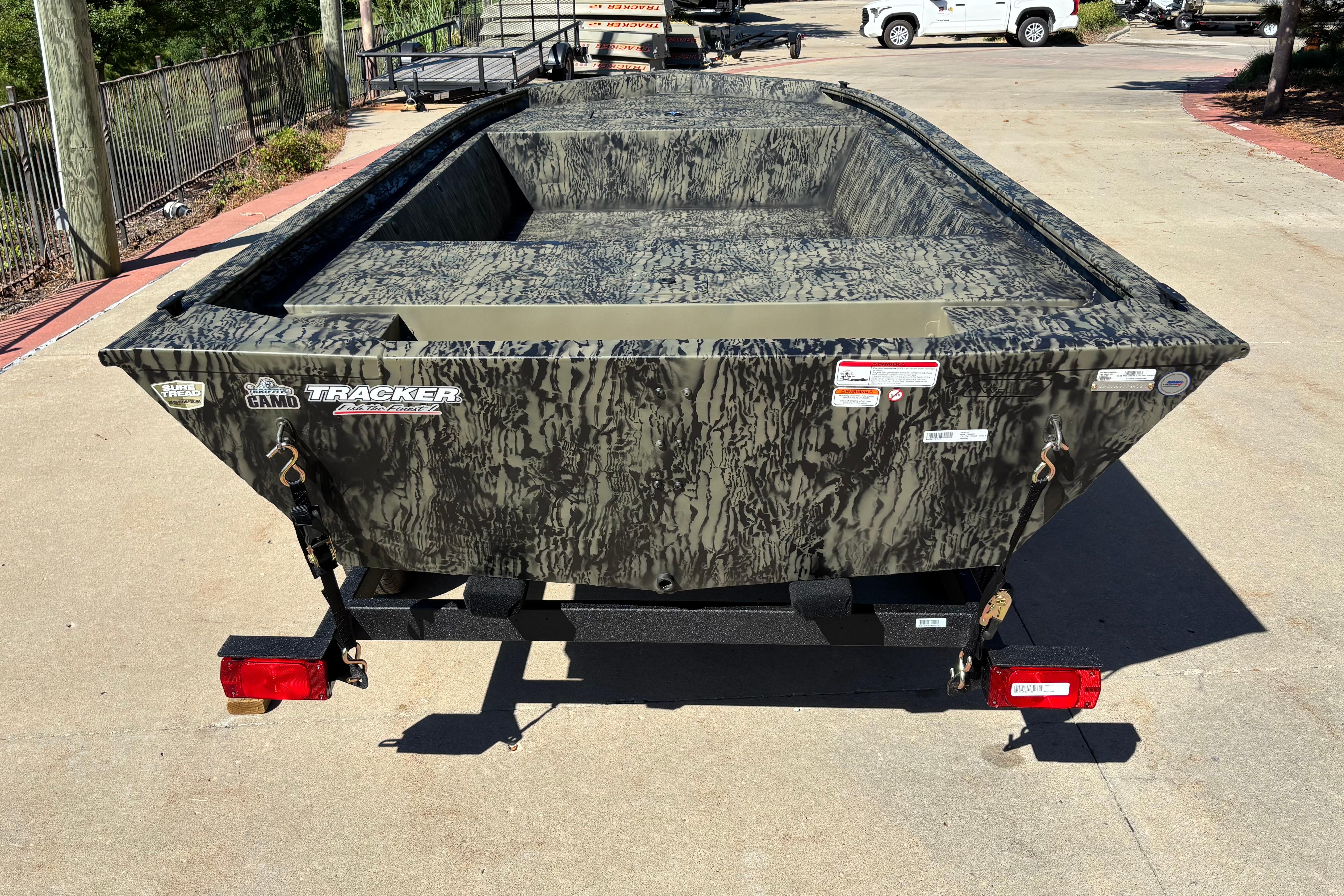 2026 Tracker Grizzly 1648 Utility boat with camouflage design on a trailer.