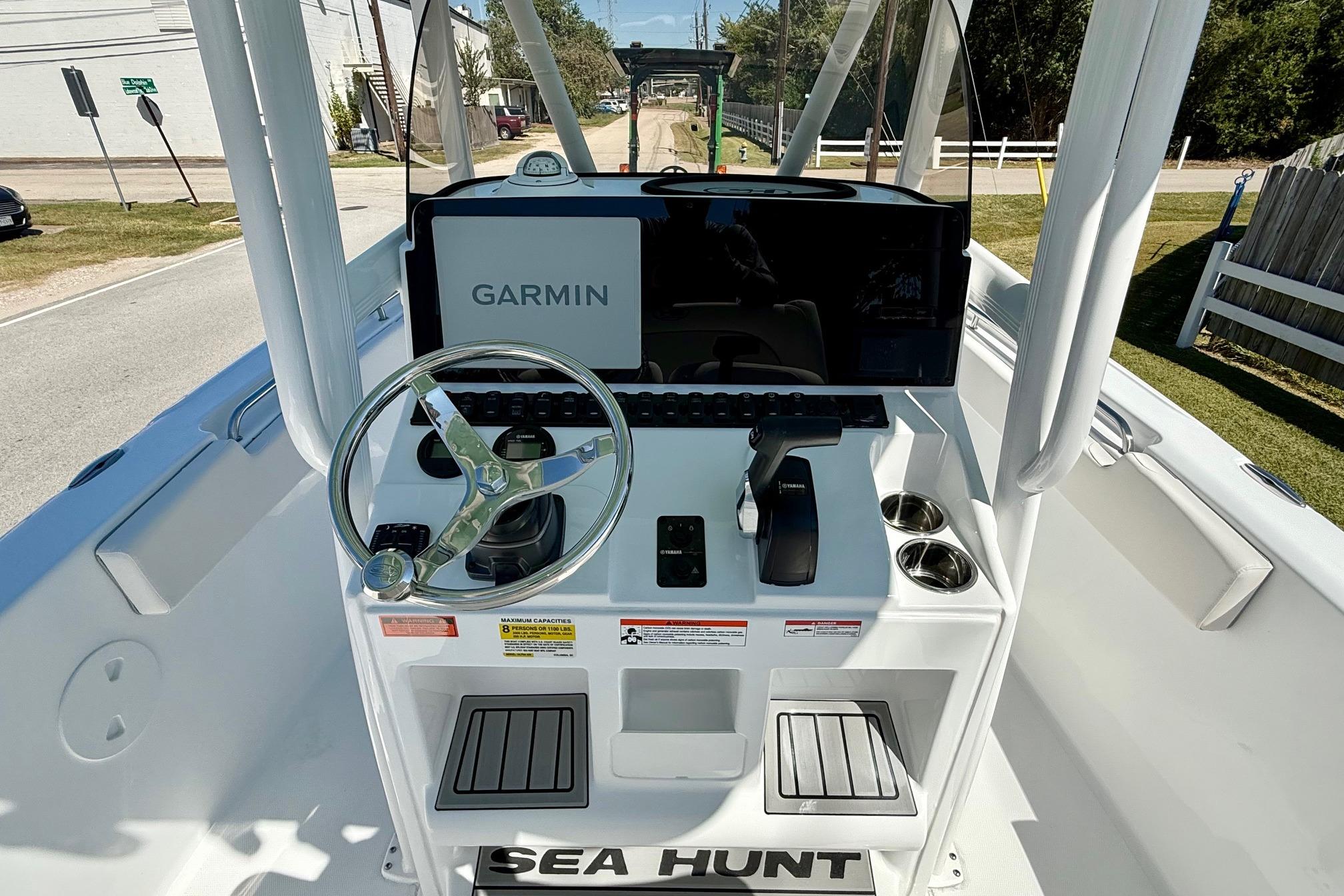 2026 Sea Hunt Ultra 229 boat console with Garmin navigation system and steering wheel.