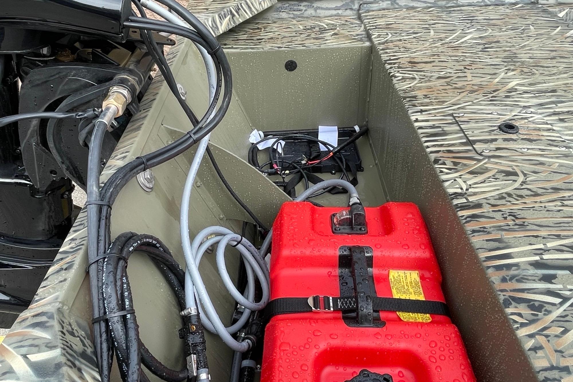2026 Tracker Grizzly 1648 SC boat interior with red fuel tank and wiring.