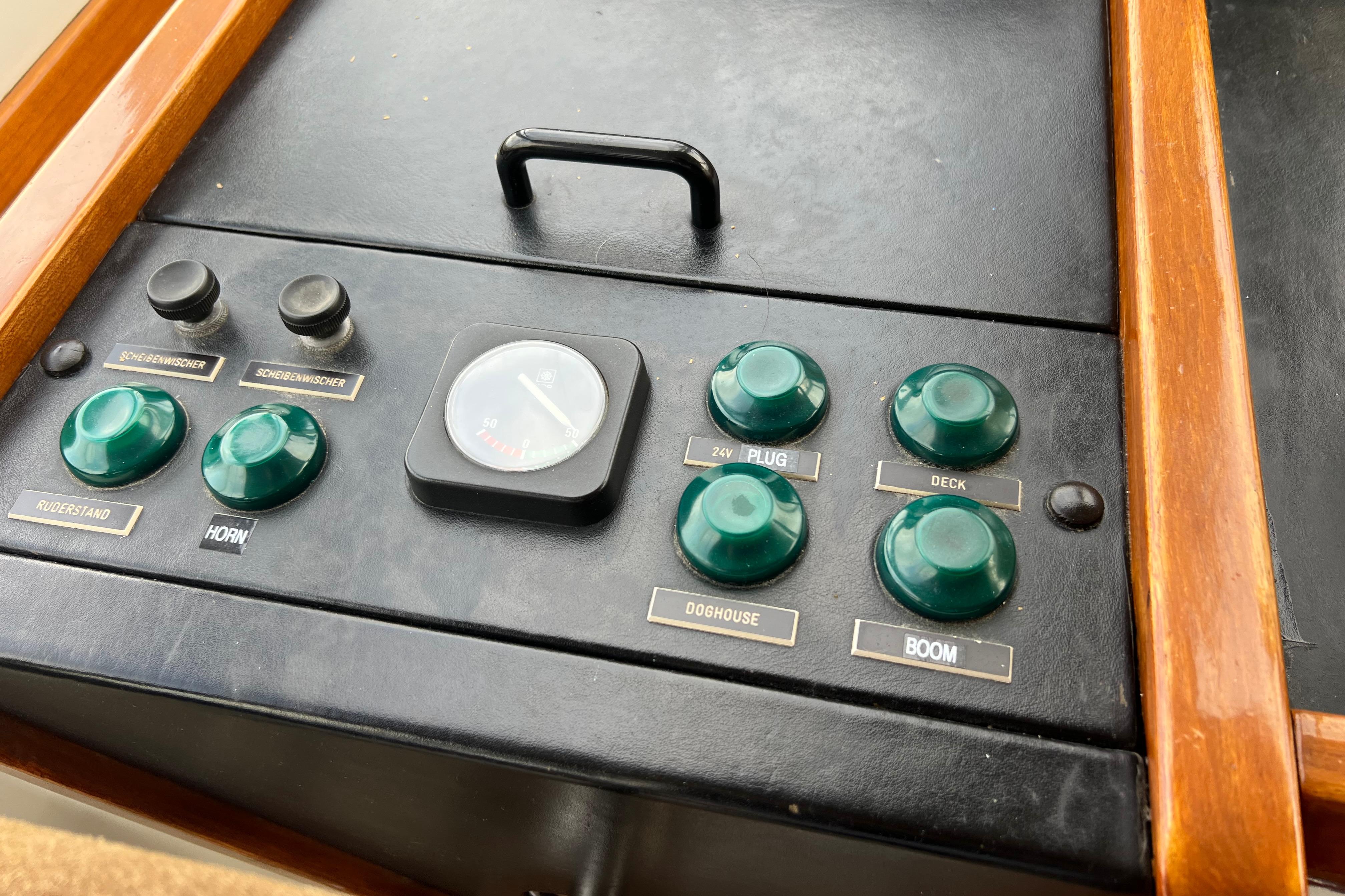 Control panel of a 1990 Trintella 49A yacht with labeled buttons and gauge.