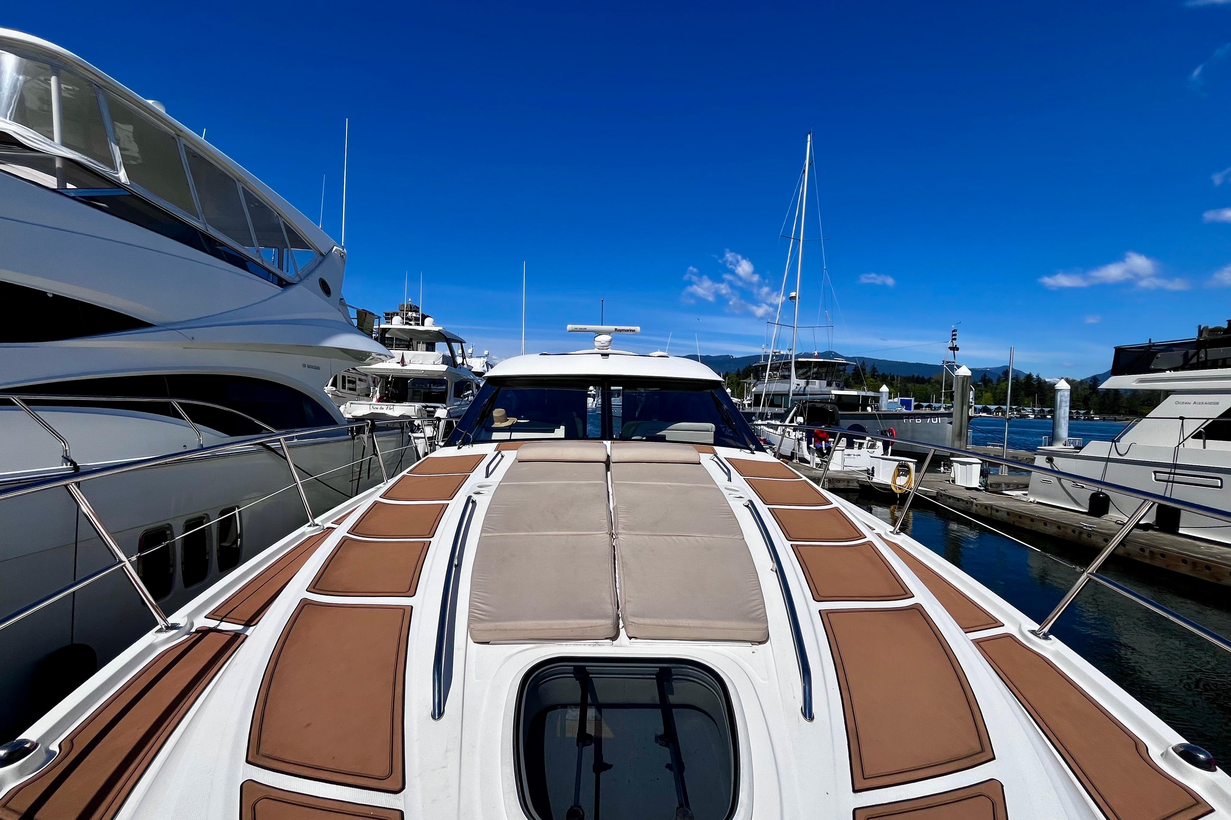 2015 Sea Ray 470 Sundancer yacht docked at marina under clear blue sky.