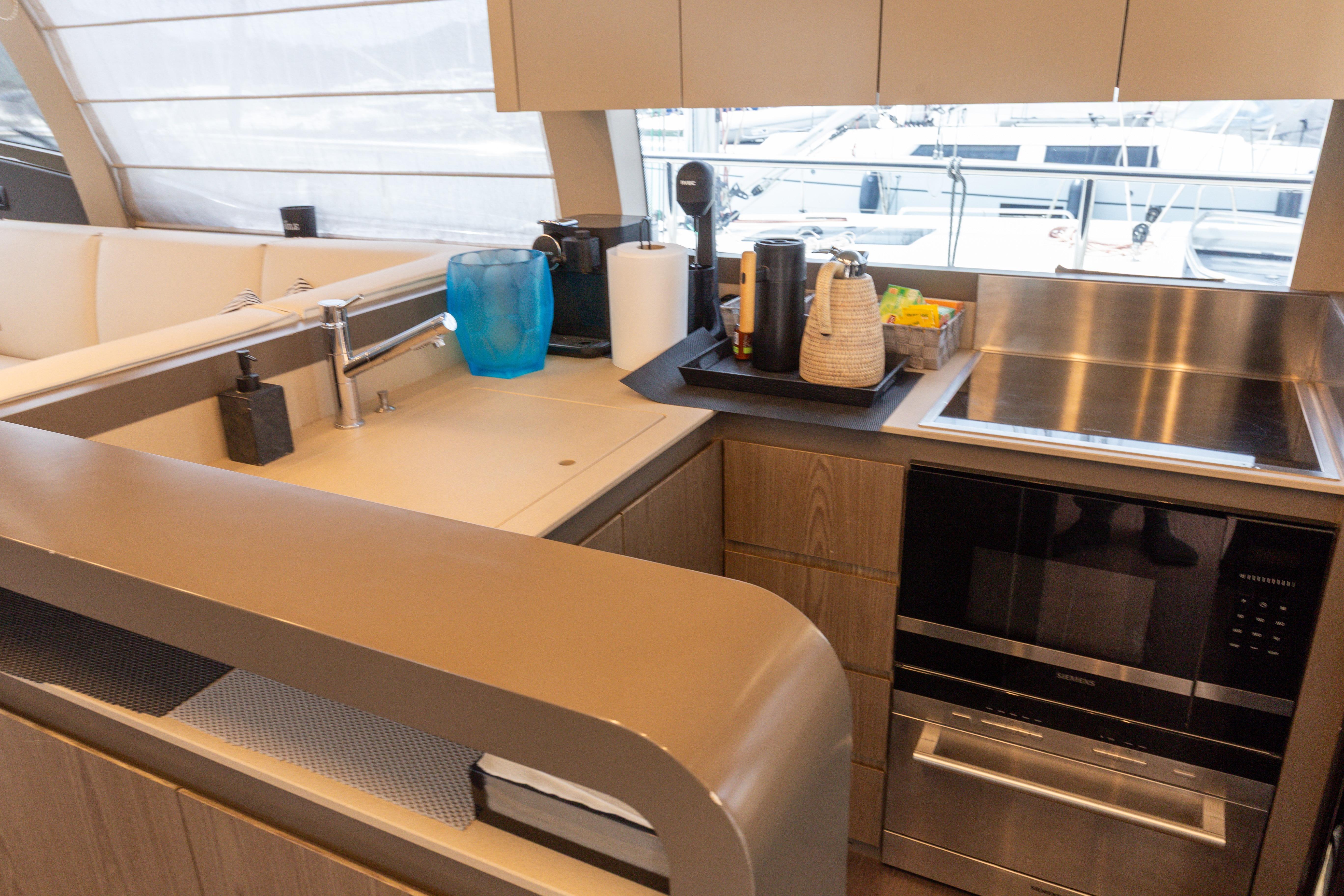 Modern kitchen interior on 2022 Ferretti Yachts 550, featuring sleek appliances and stylish design.