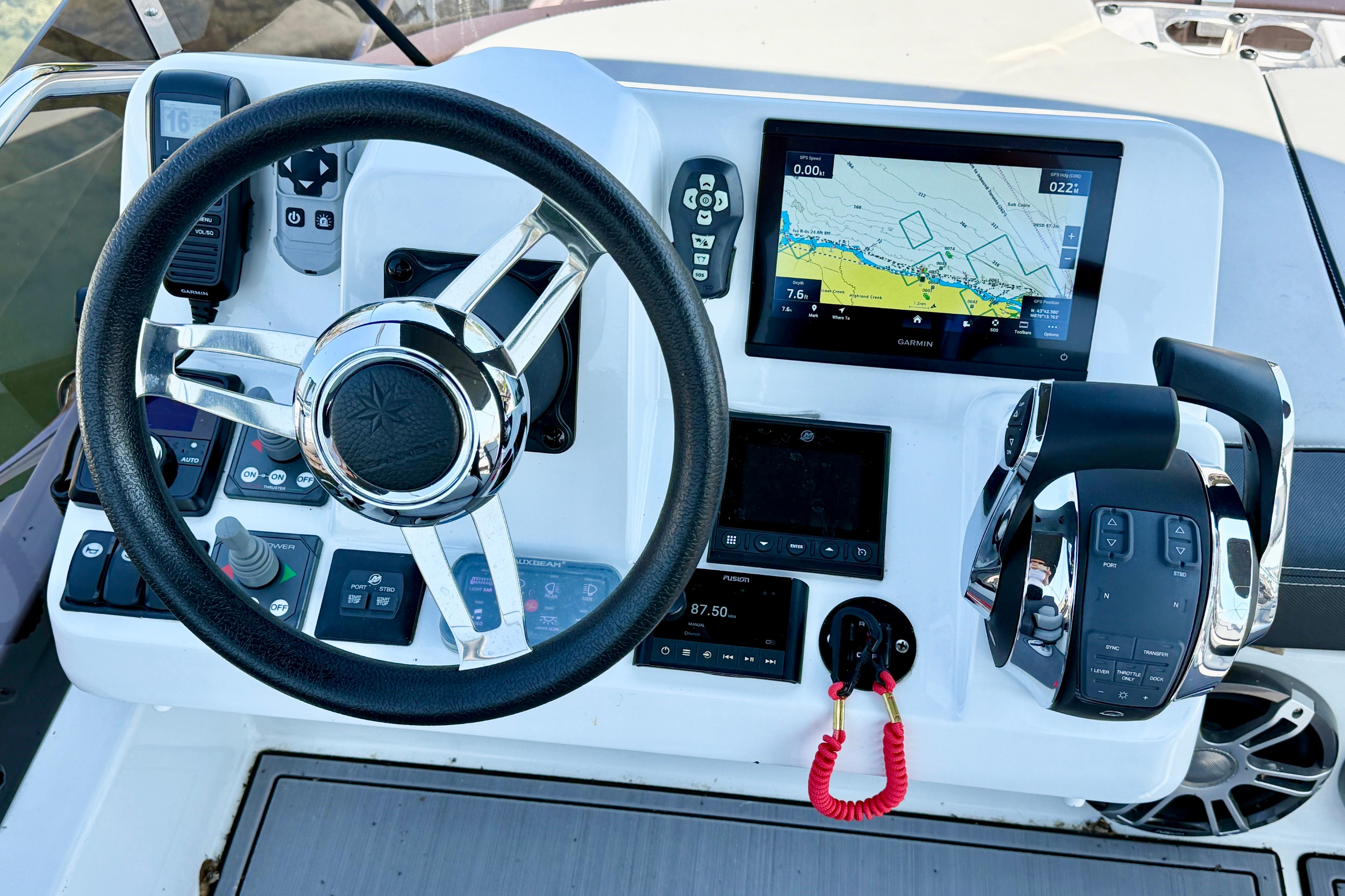 Cockpit of 2022 Jeanneau NC 1095 Fly with steering wheel and navigation display.
