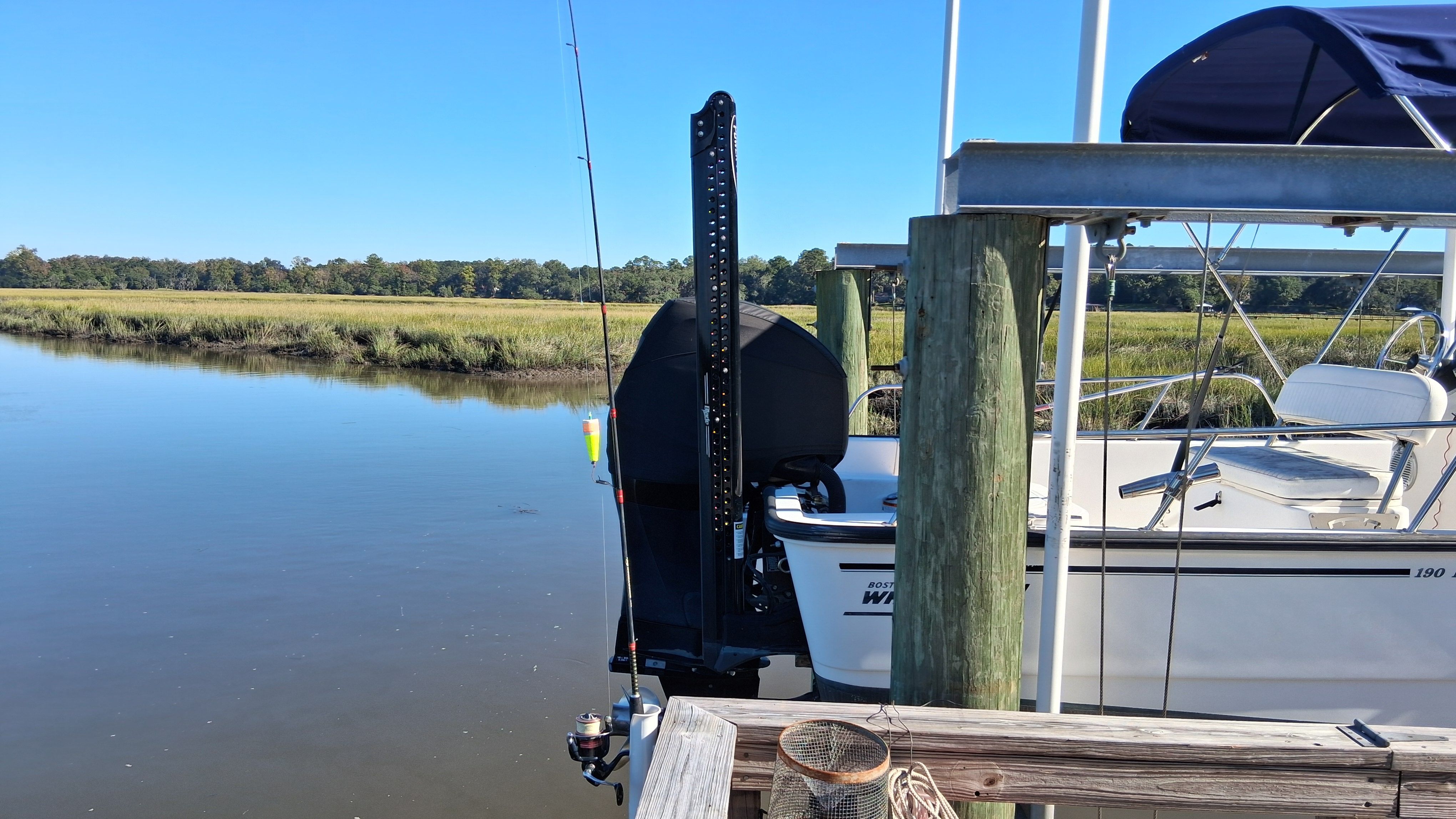 Boston Whaler 190 Montauk 2012 docked at serene riverside.