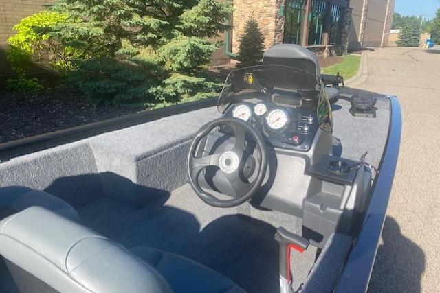 2026 Tracker Pro 170 boat interior with steering wheel and dashboard, parked outdoors.