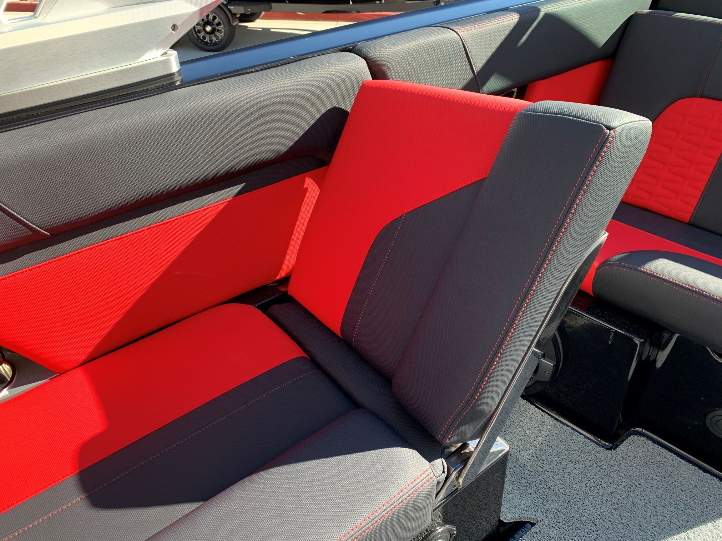 The 2020 MasterCraft X24 interior features red and gray upholstery.