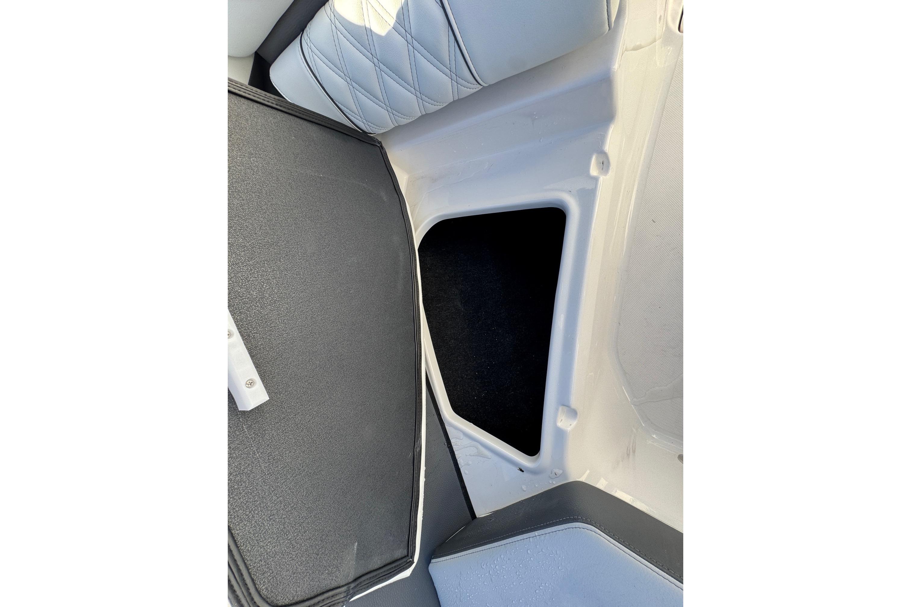2026 Regal 21 OBX boat interior storage compartment with cushioned seating.