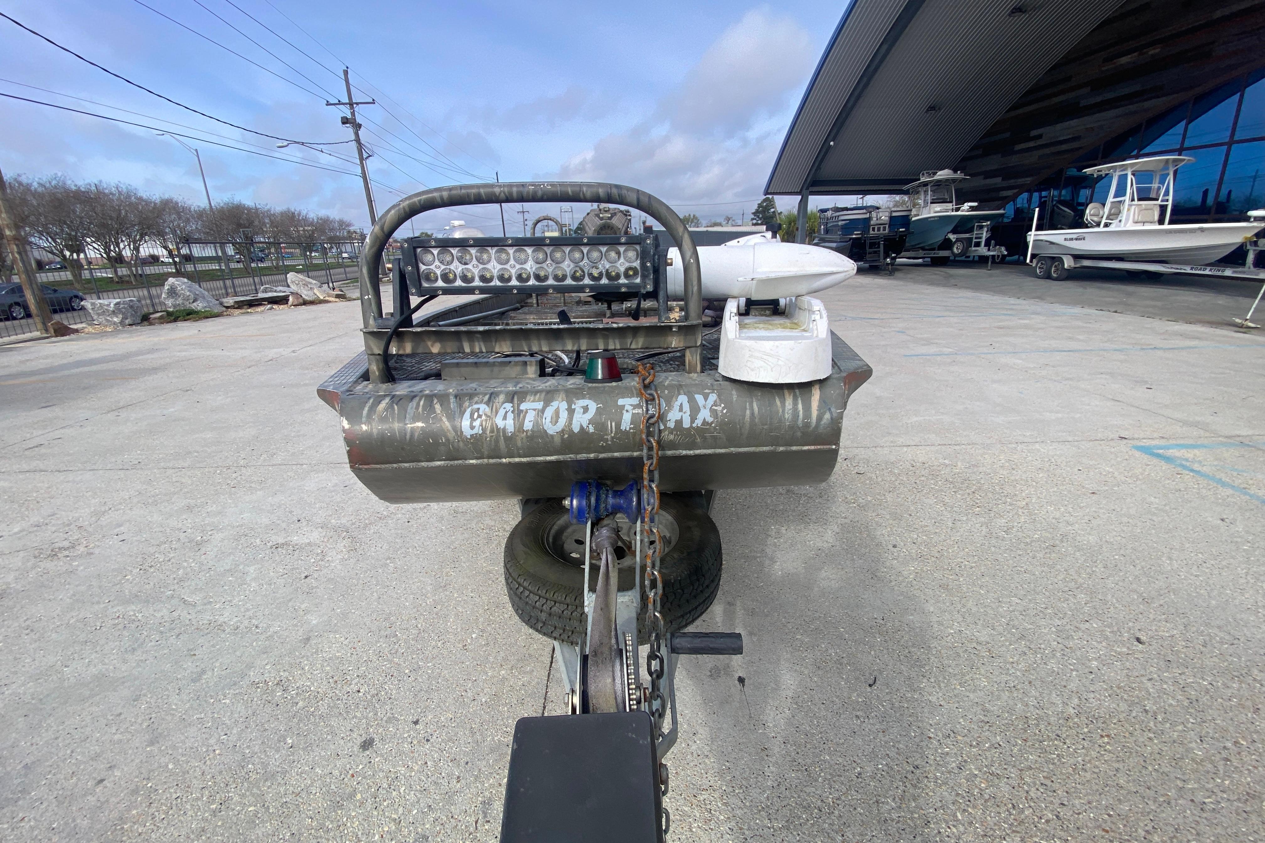 2009 Gator Trax MUD BUDDY 17 X 50 boat on trailer, outdoor dealership setting.