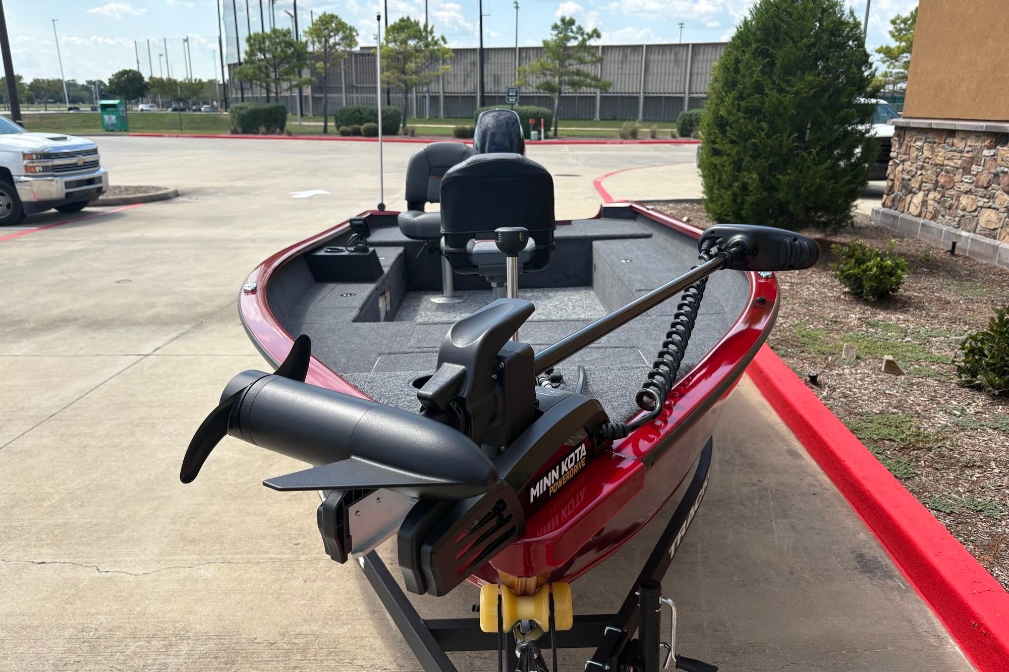 2026 Tracker Super Guide V-16 T boat with Minn Kota motor in parking lot.