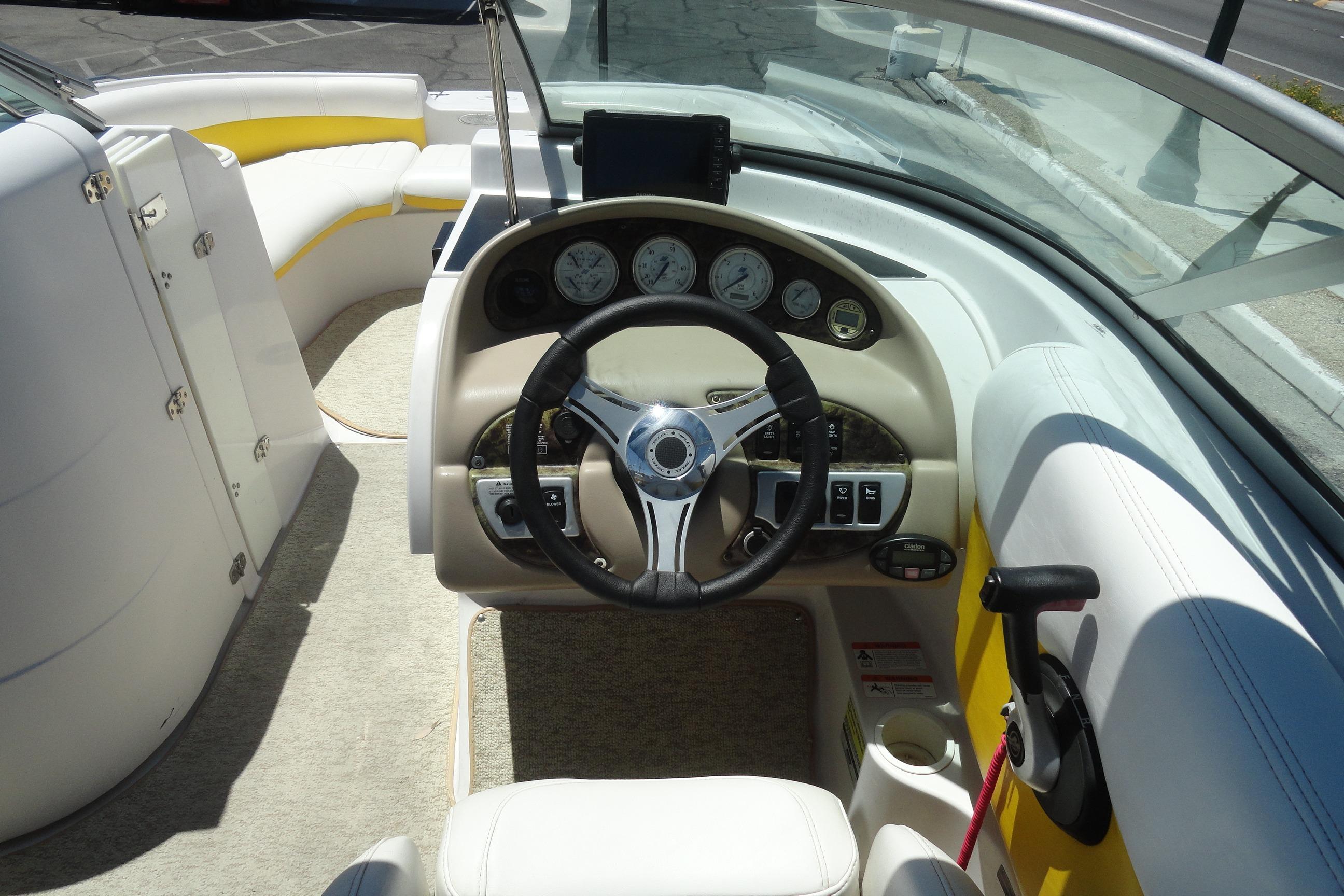 2005 Four Winns 214 Funship boat cockpit with steering wheel and dashboard controls.