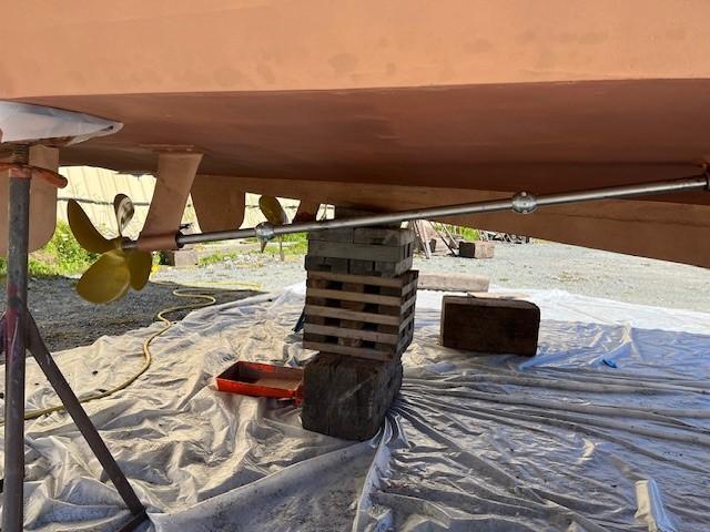 1965 Chris-Craft 460 Constellation boat underbody with propeller and support stands.