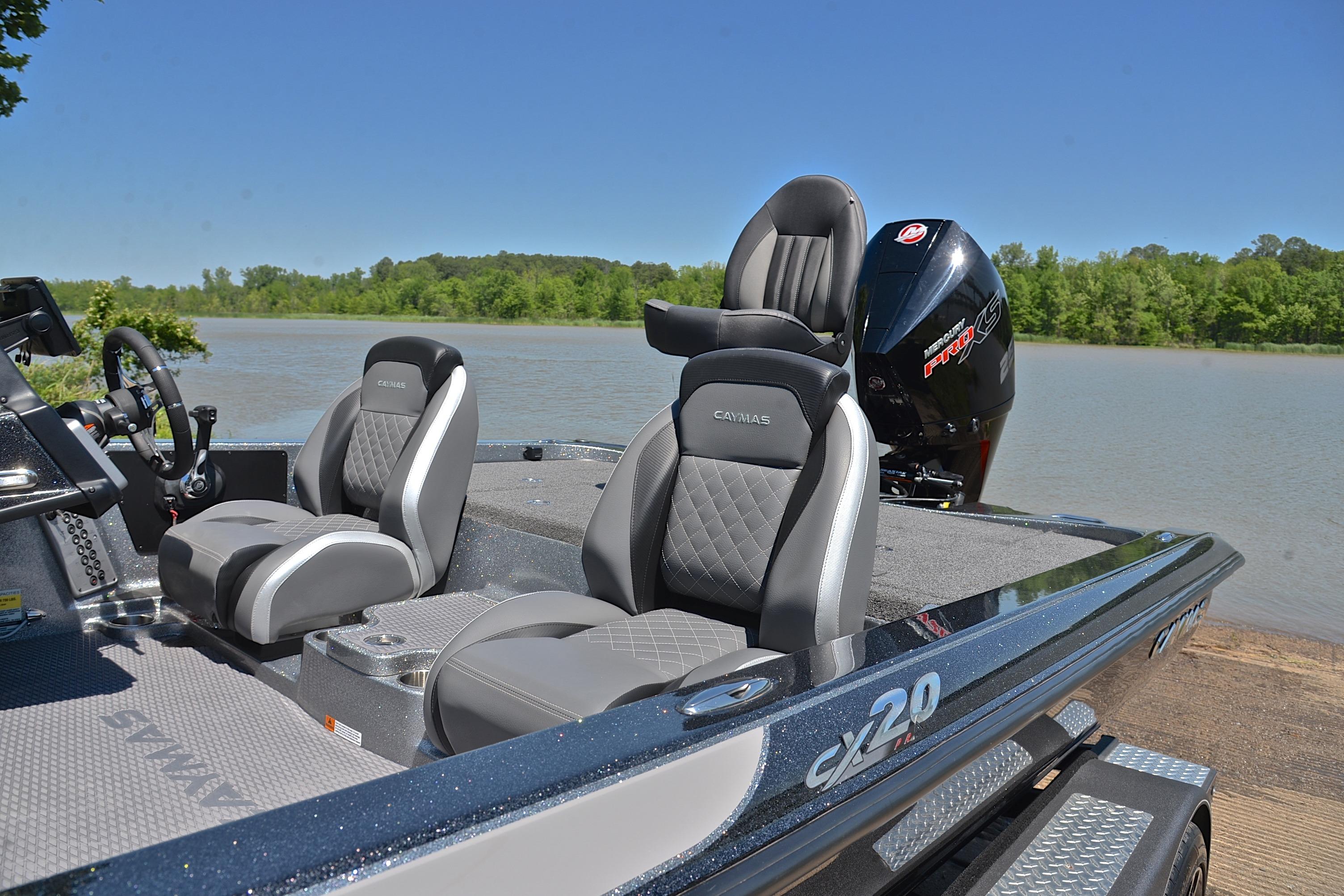 2022 Caymas CX 20 boat with sleek seating, docked by a serene lake.