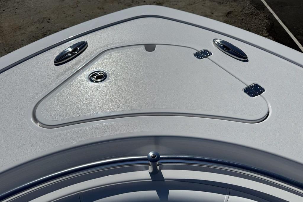 2026 Sportsman Open 232 Center Console boat deck with storage compartment.