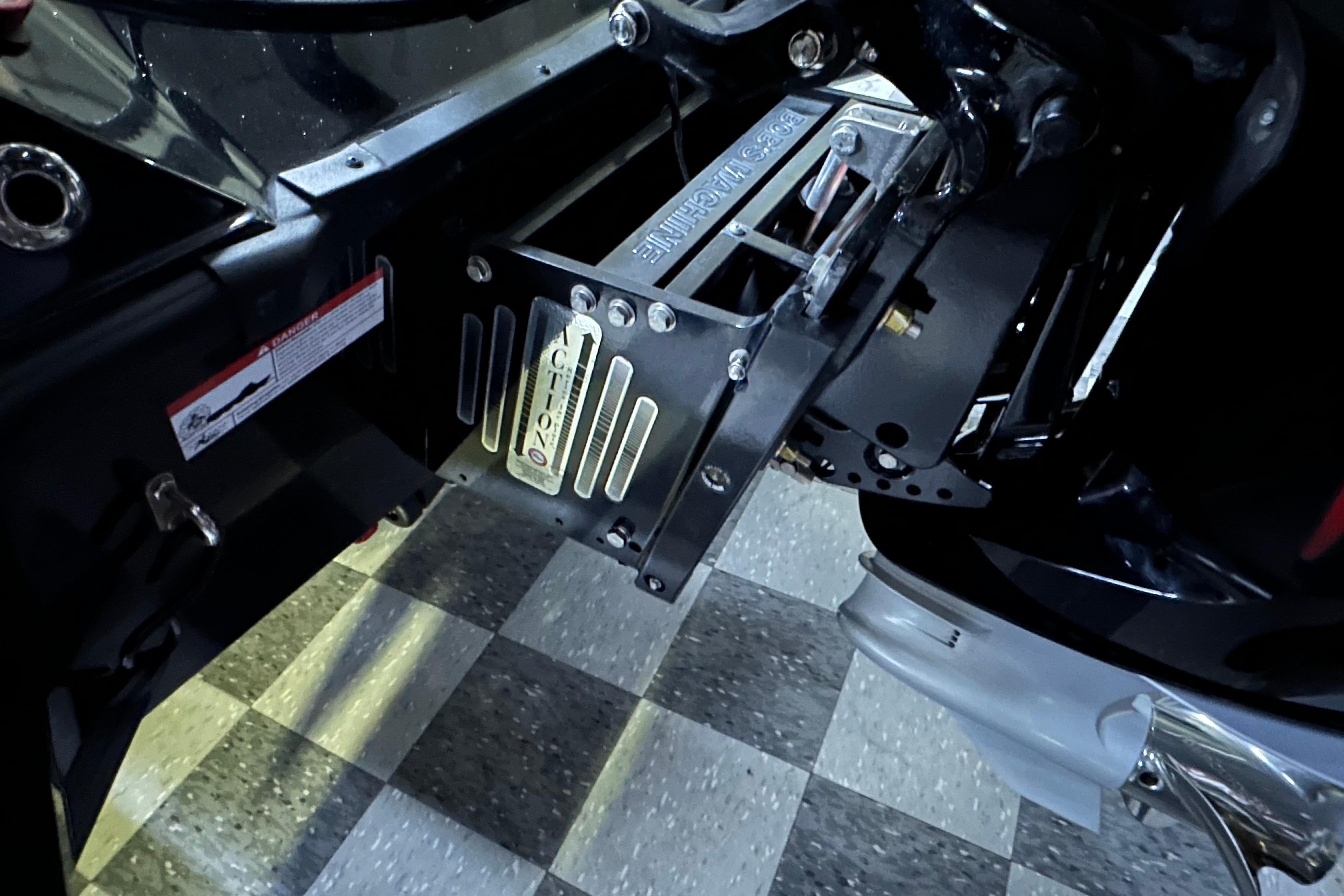 2025 Triton 21XP Patriot boat engine mount on checkered floor.