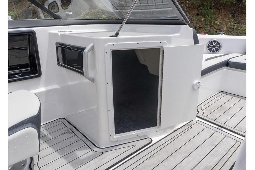 2021 Yamaha Boats 195S interior storage compartment with open door, showcasing sleek design.
