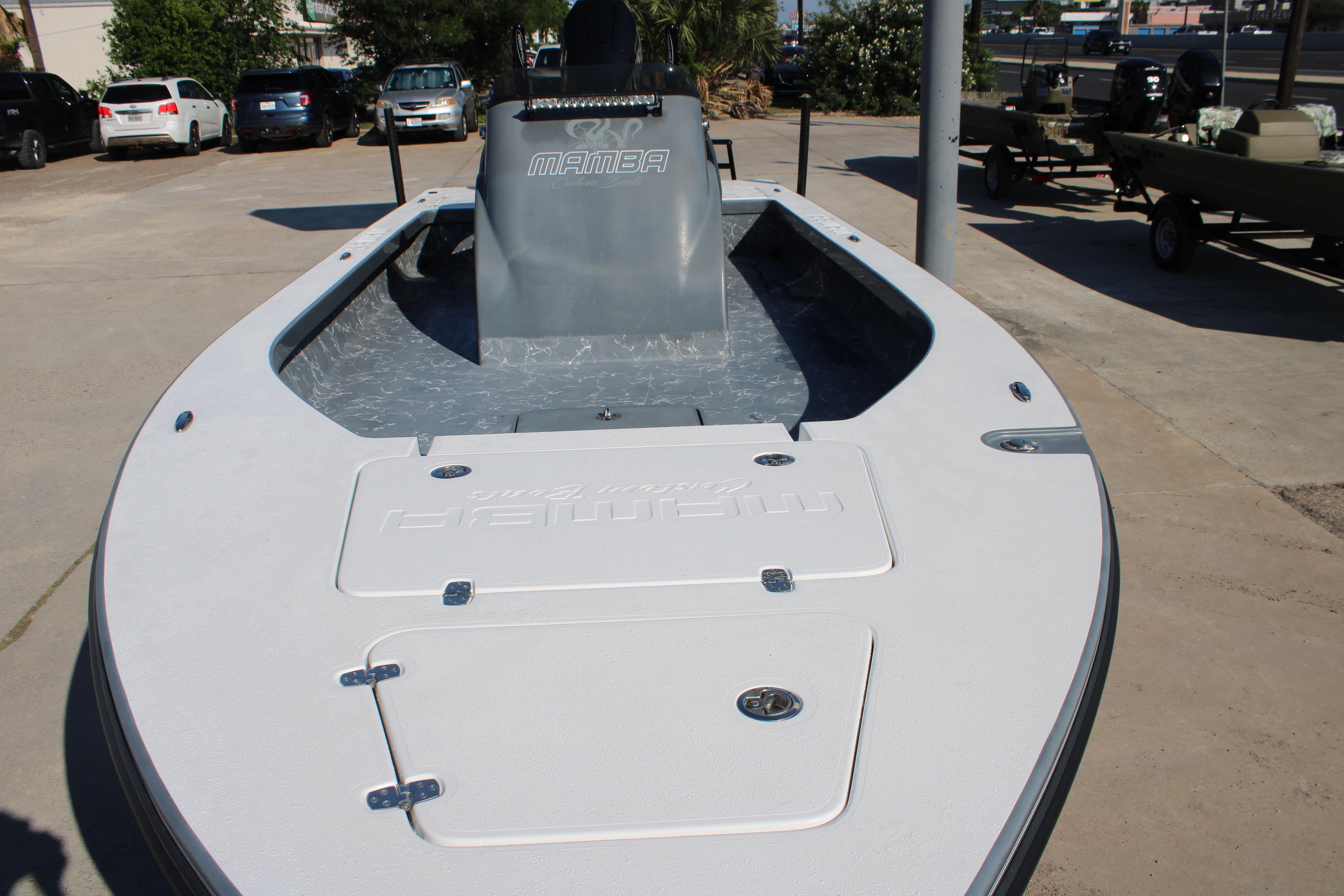2023 Mamba 24VX boat on display in a parking lot.