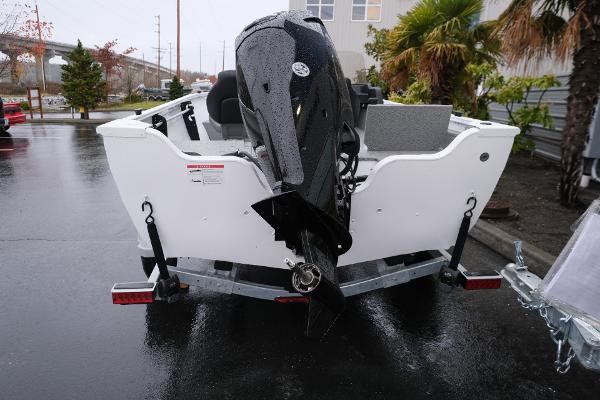 2024 Crestliner 1600 Vision boat on trailer, rear view, parked outdoors.