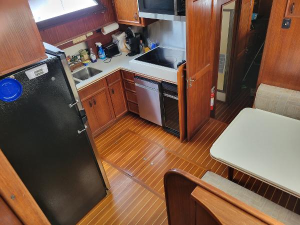 Interior view of a 1980 Hatteras 53 Yacht Fisherman with kitchen and dining area.