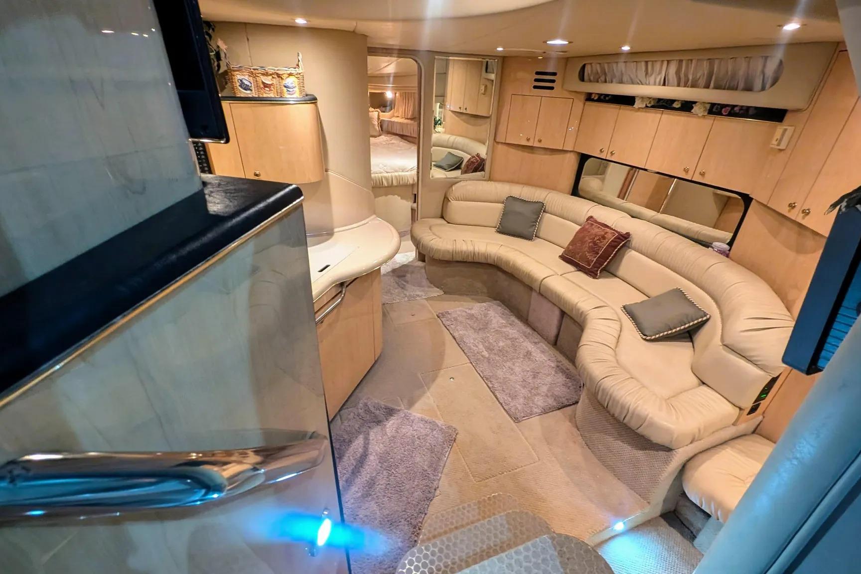 Luxurious interior of a 2000 Sea Ray 380 Sundancer yacht with plush seating and modern amenities.