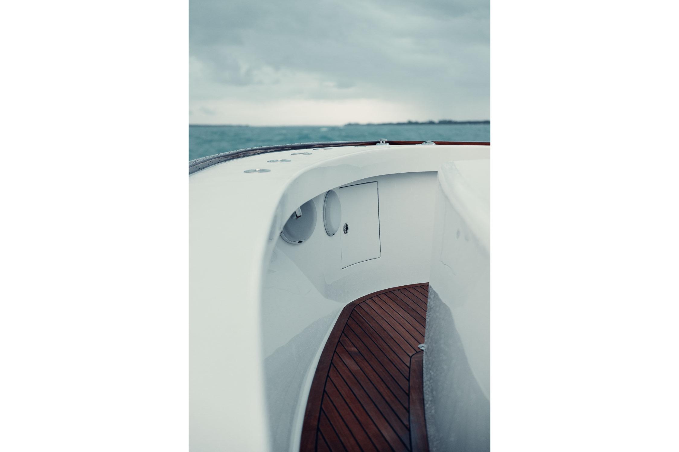 2026 Release Boatworks 46 Walkaround, sleek deck design, wooden flooring, ocean backdrop.