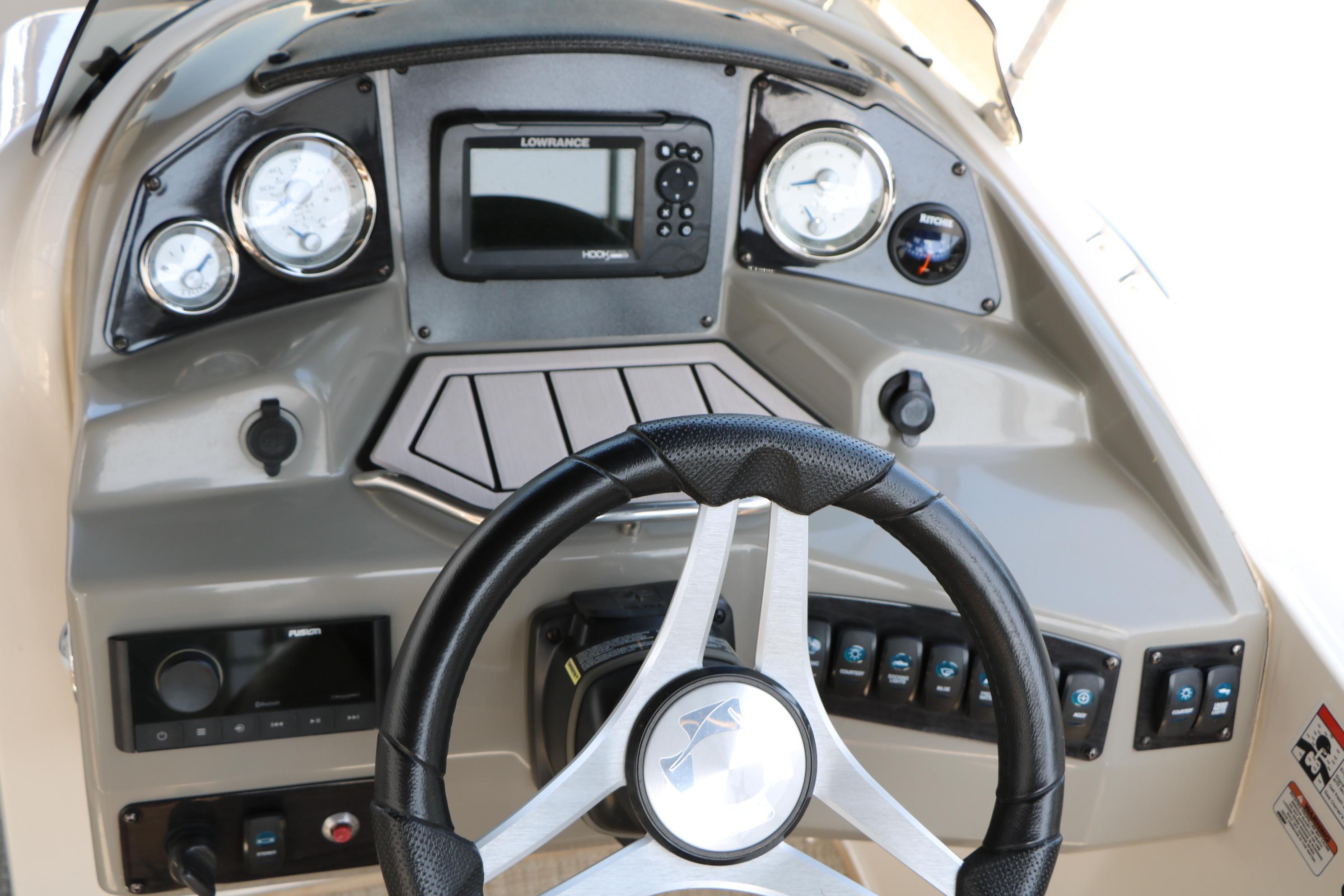 2022 Stingray 192 SC boat dashboard with steering wheel, gauges, and control panel.