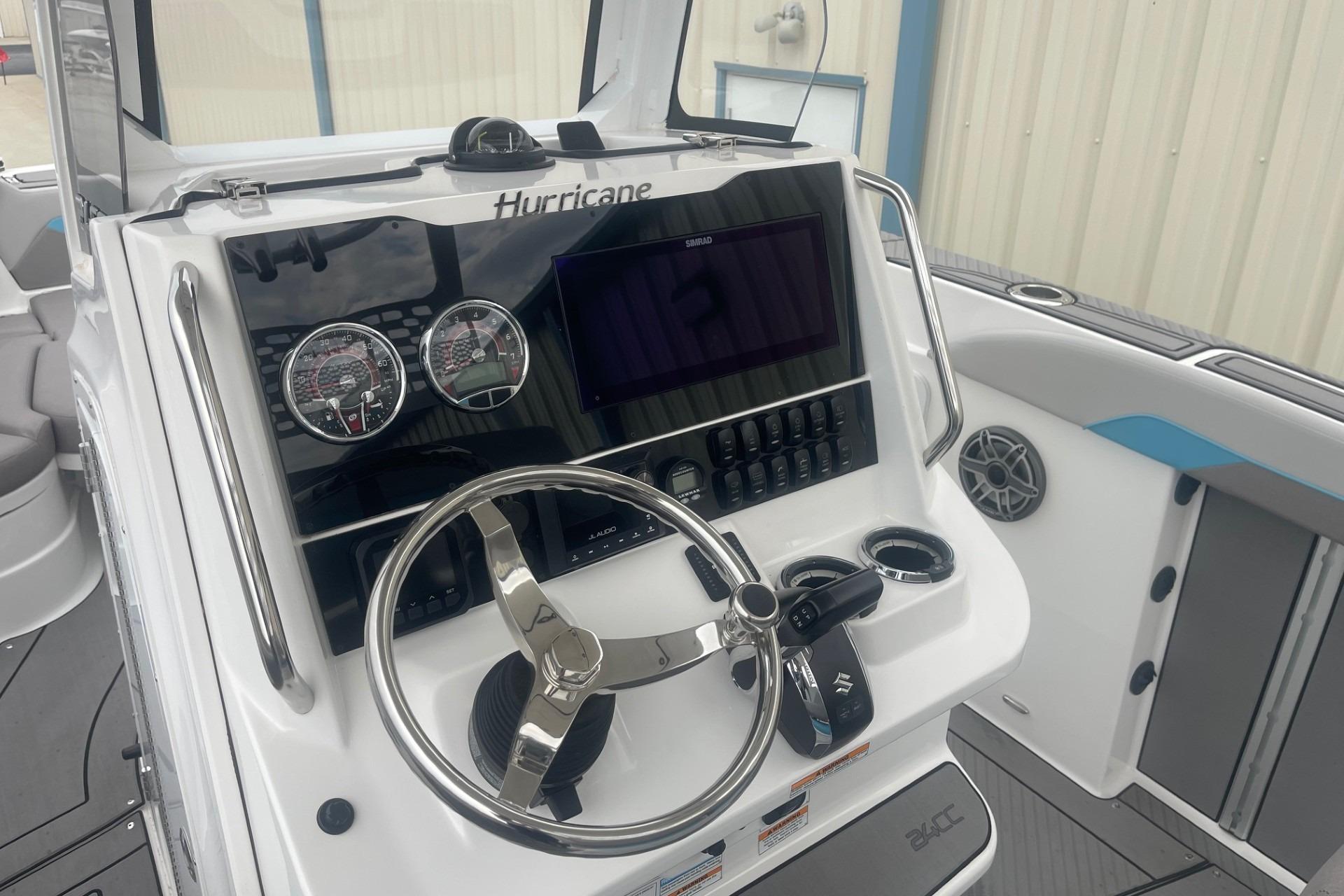 2025 Hurricane Center Console 24 OB boat dashboard with steering wheel and controls.
