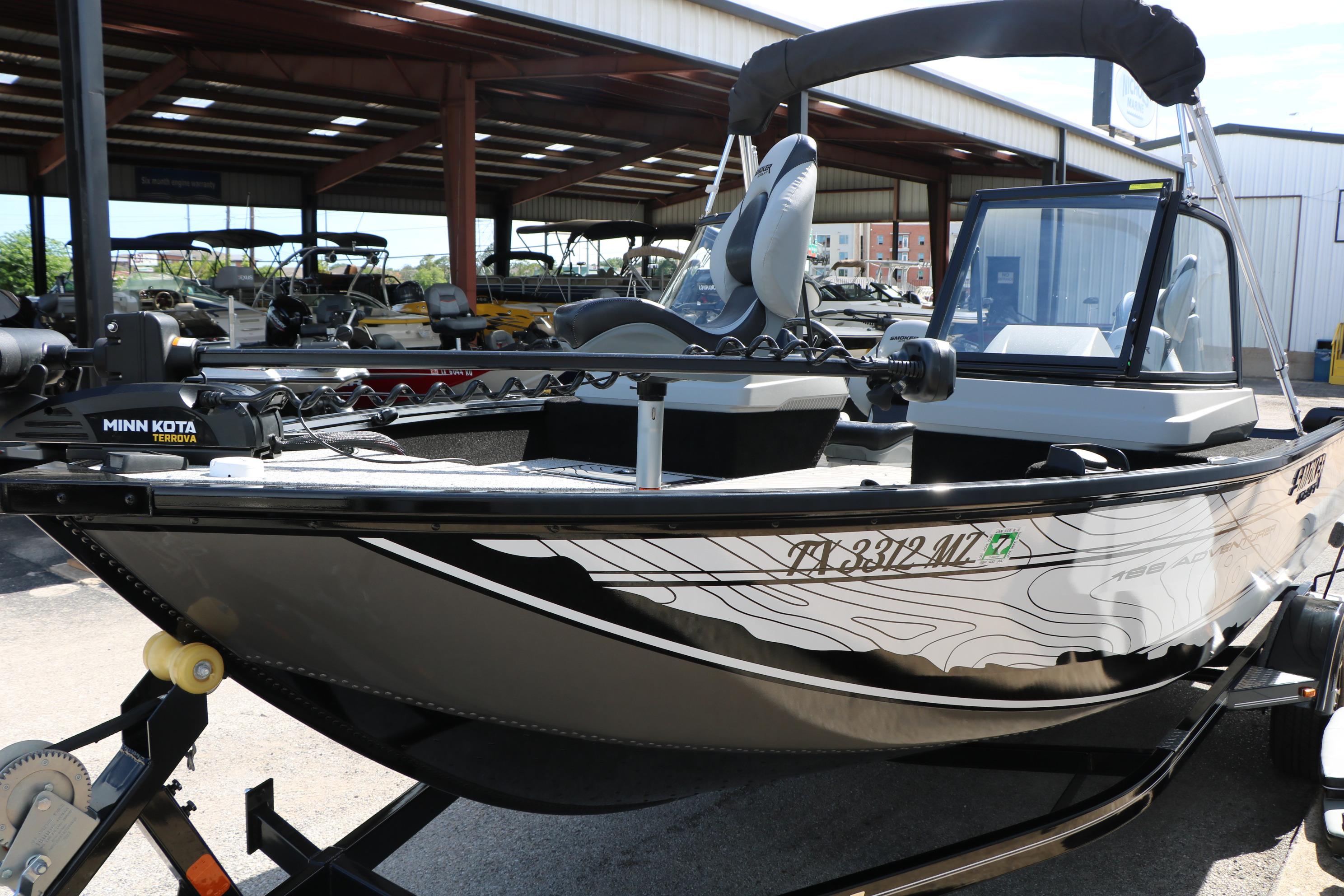 2025 Smoker Craft Adventurer 188 DC boat with Minn Kota motor in a marina setting.
