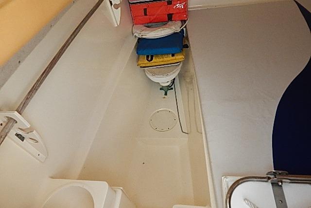 2003 World Cat 270 EC boat interior with compact bathroom and storage.