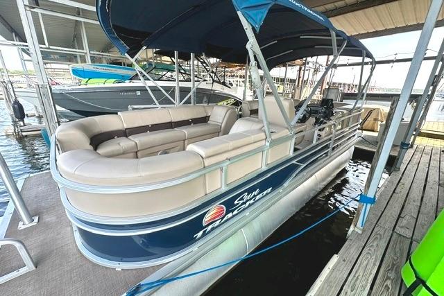 2019 Sun Tracker Party Barge 22 XP3 pontoon boat docked under a canopy.