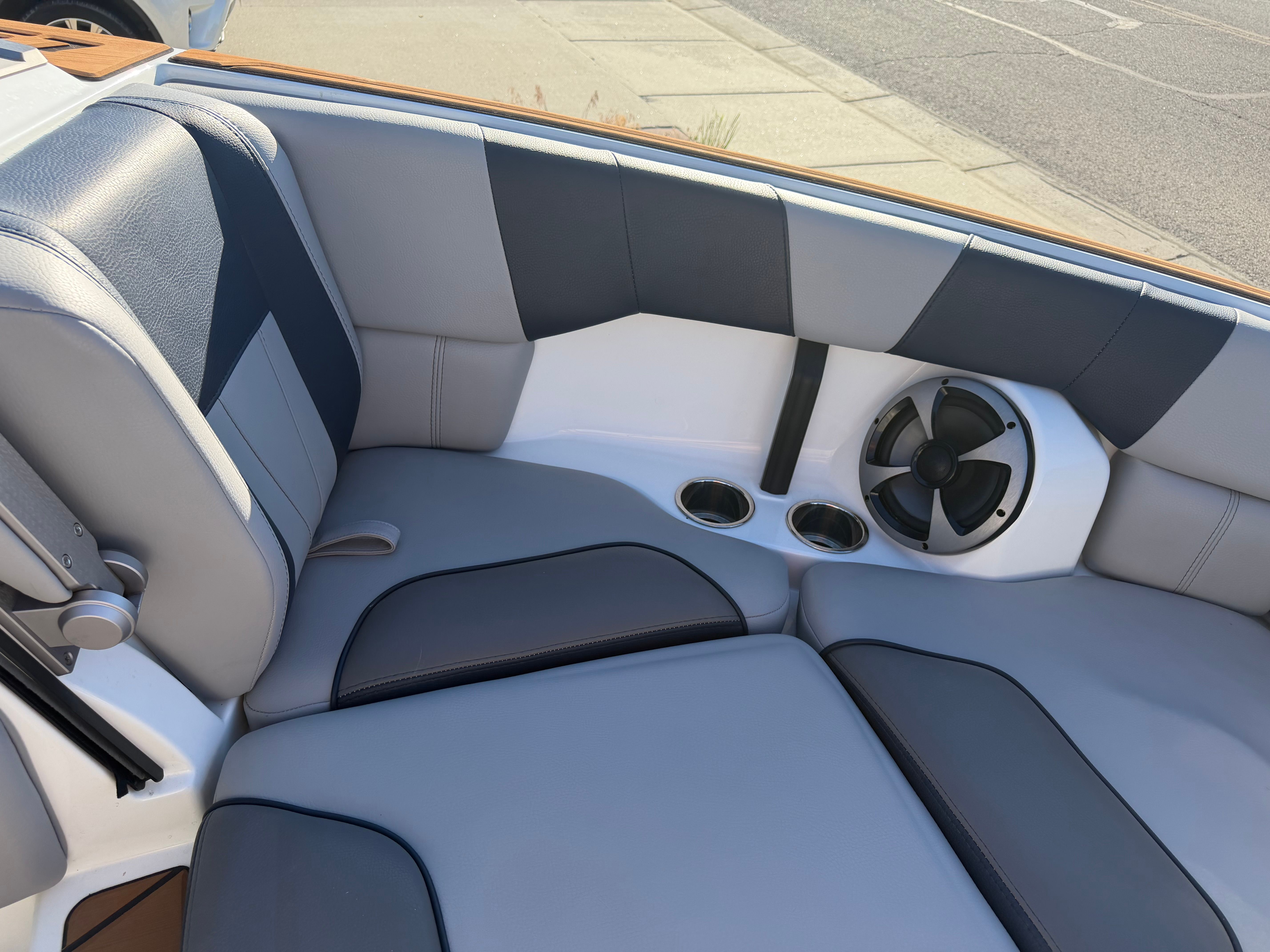 Interior of a 2021 Malibu Wakesetter 23 LSV with gray and blue upholstery and a speaker.