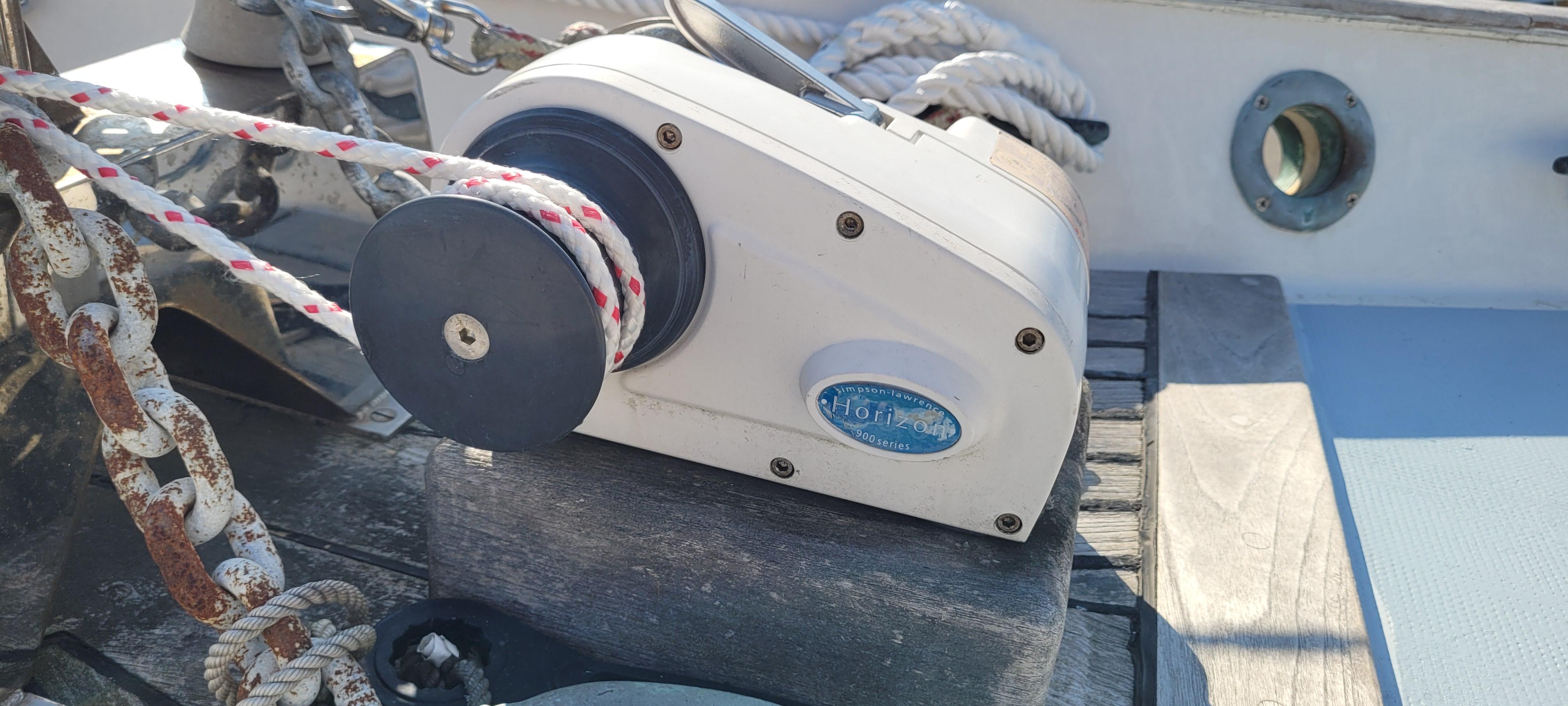 1976 Westsail Ketch winch with ropes on deck, sunlight casting shadows.