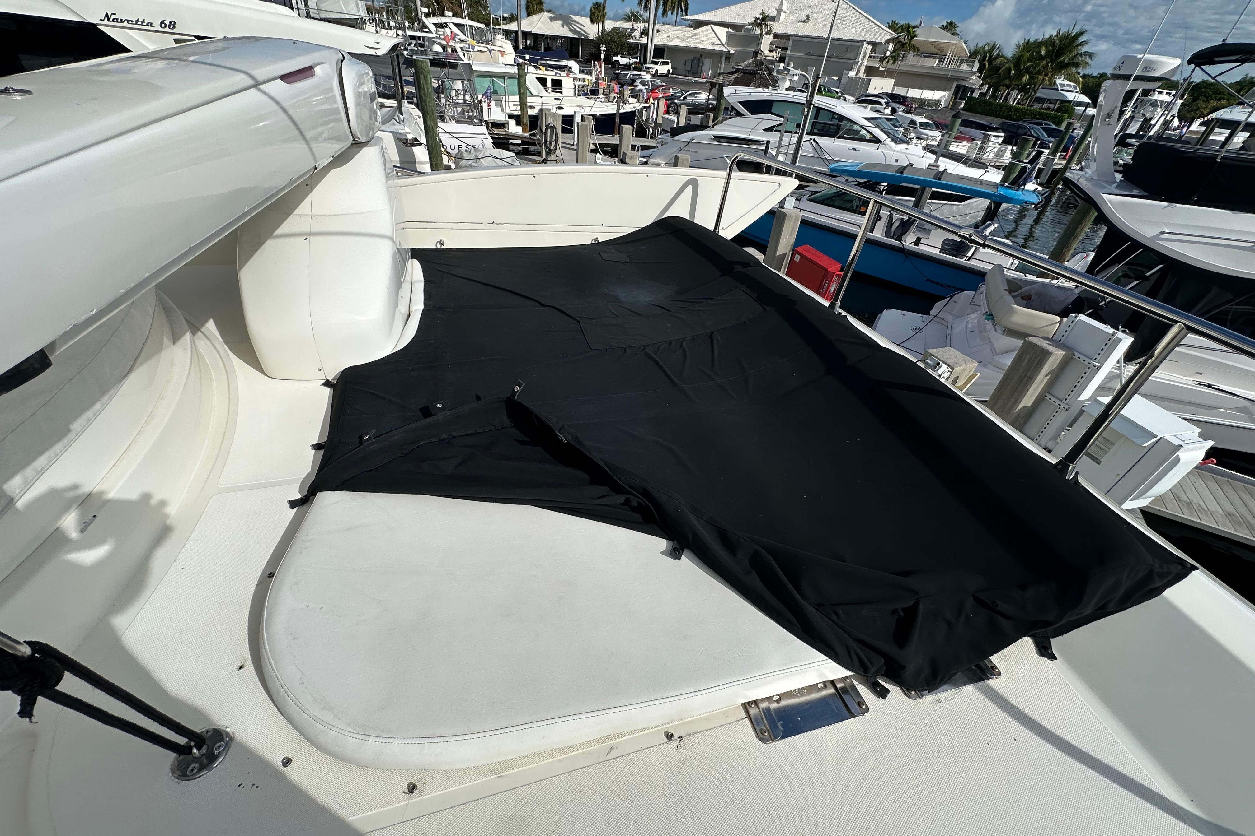 2004 Azimut 55E yacht deck with black cover, docked at marina.
