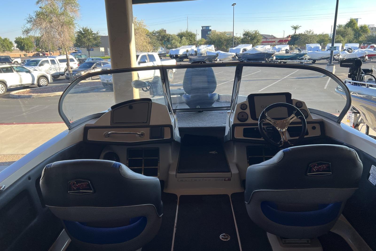 Interior view of 2025 Ranger 212LS boat with dual seats and steering console.