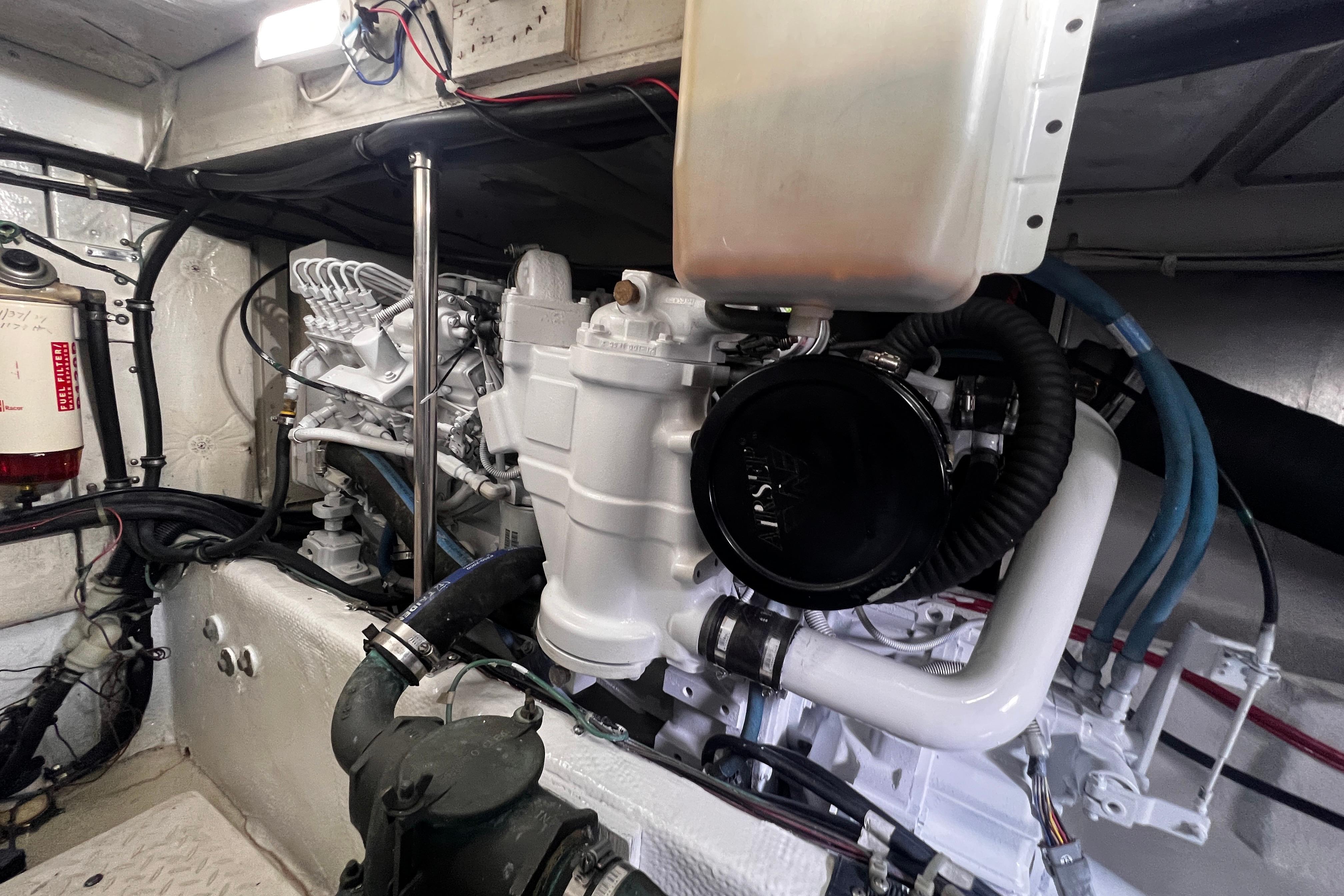 Engine room of 1999 Bayliner 3988 Command Bridge Motoryacht, showcasing mechanical components.